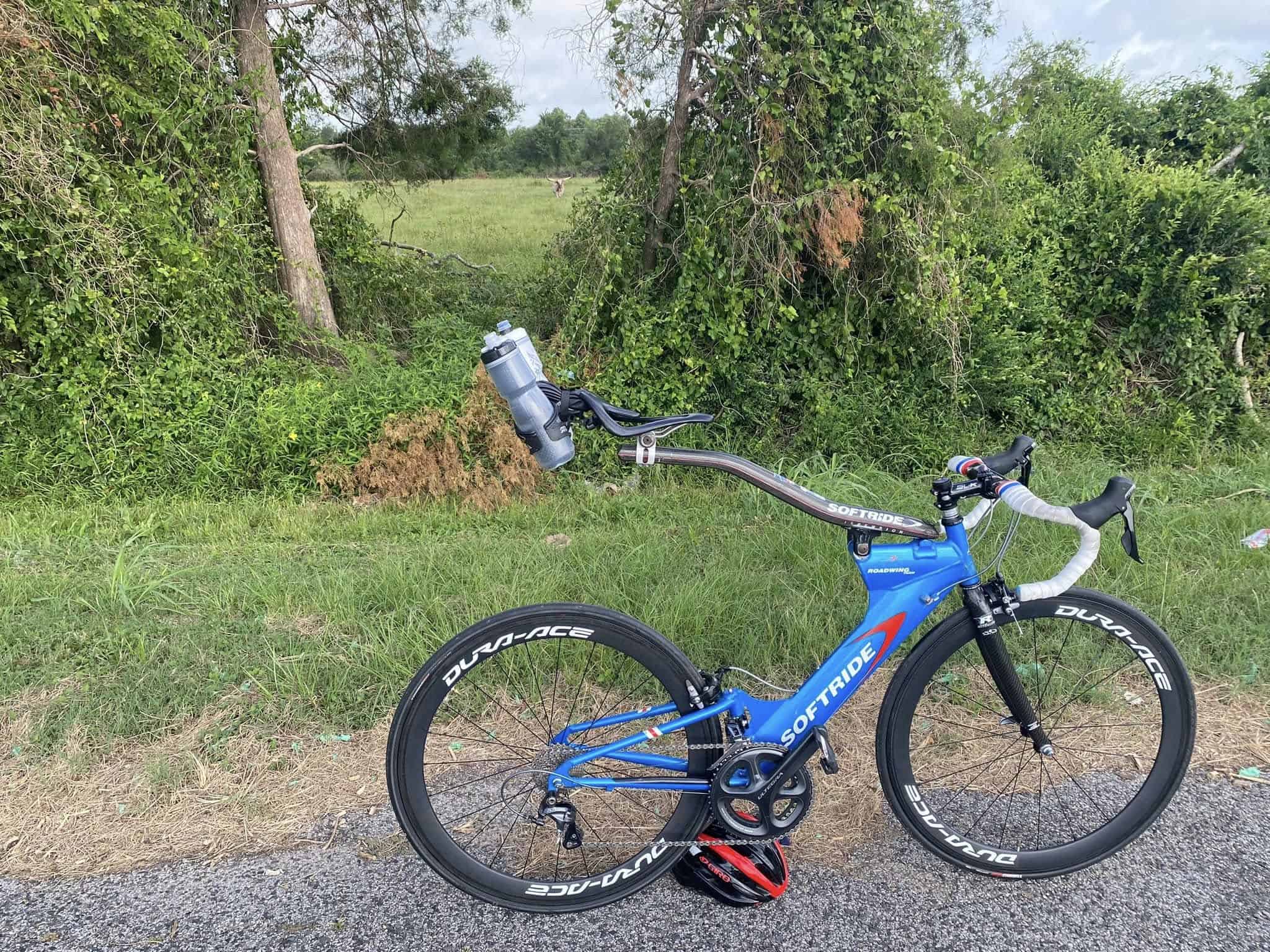 Bright blue Soft Ride road bike with Dura-Ace wheels for high-performance cycling.