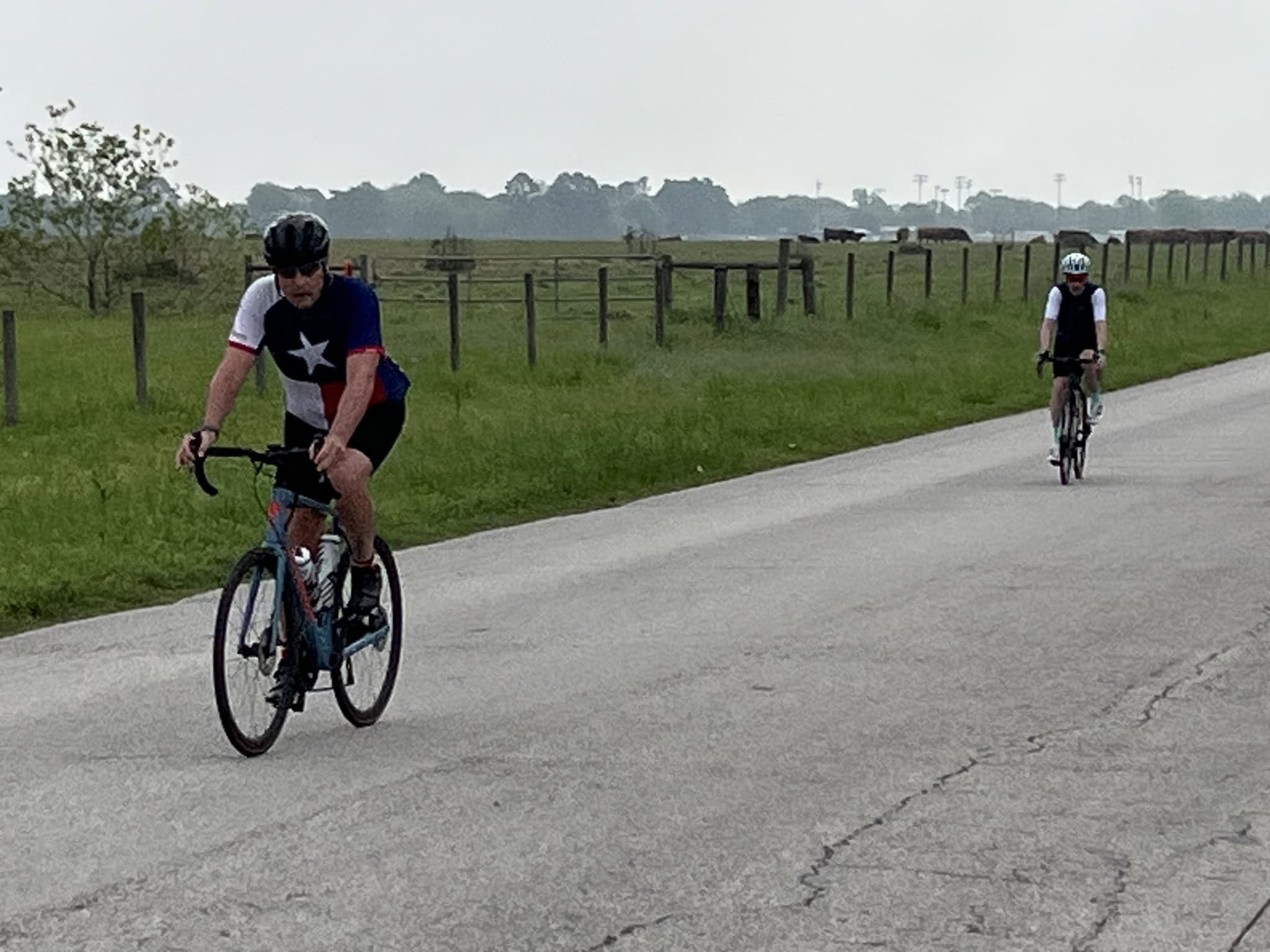 Riders on a scenic rural bike route, enjoying outdoor cycling adventure on a clear day.