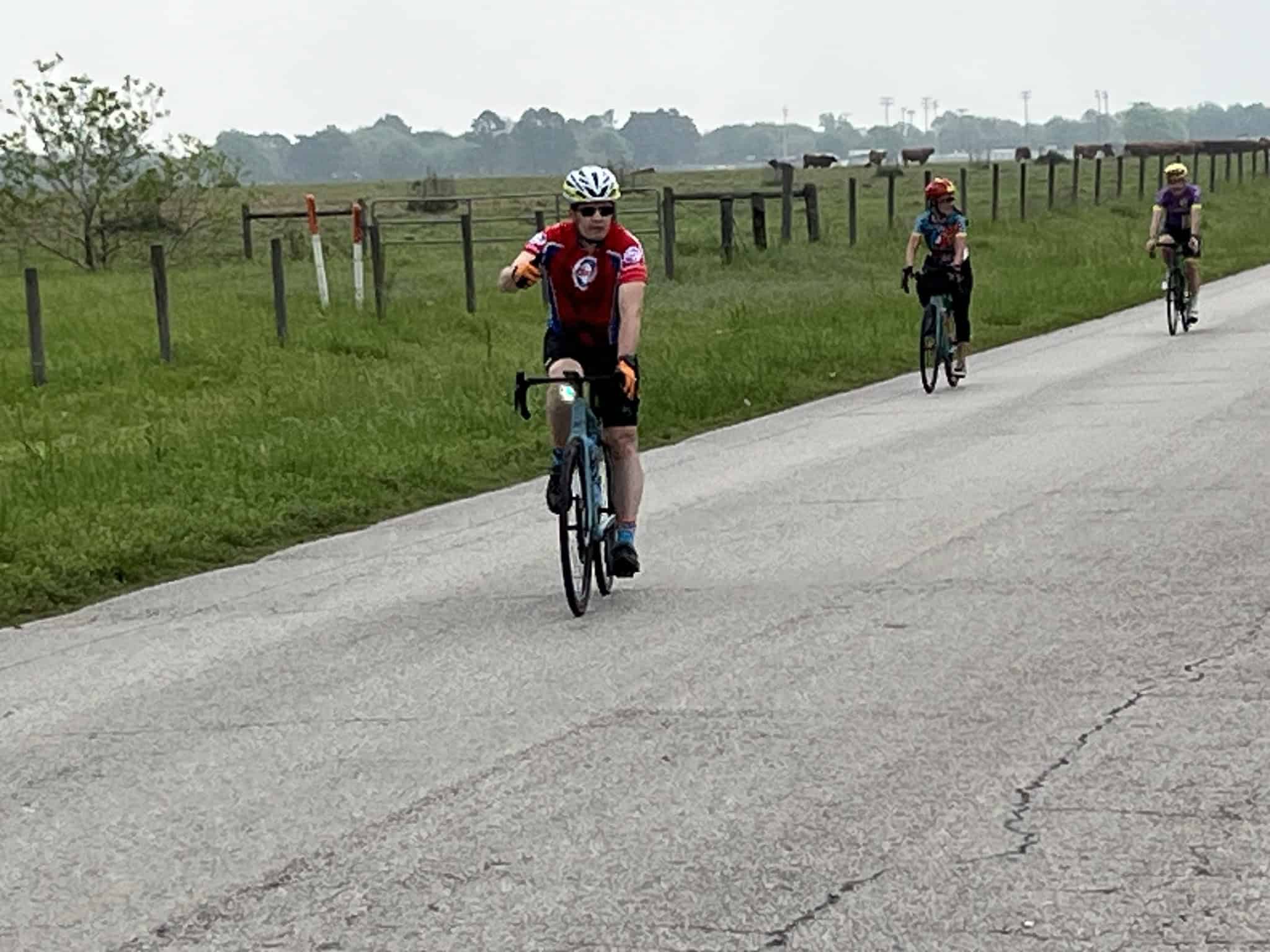Cyclists riding on a rural road enjoying outdoor biking.