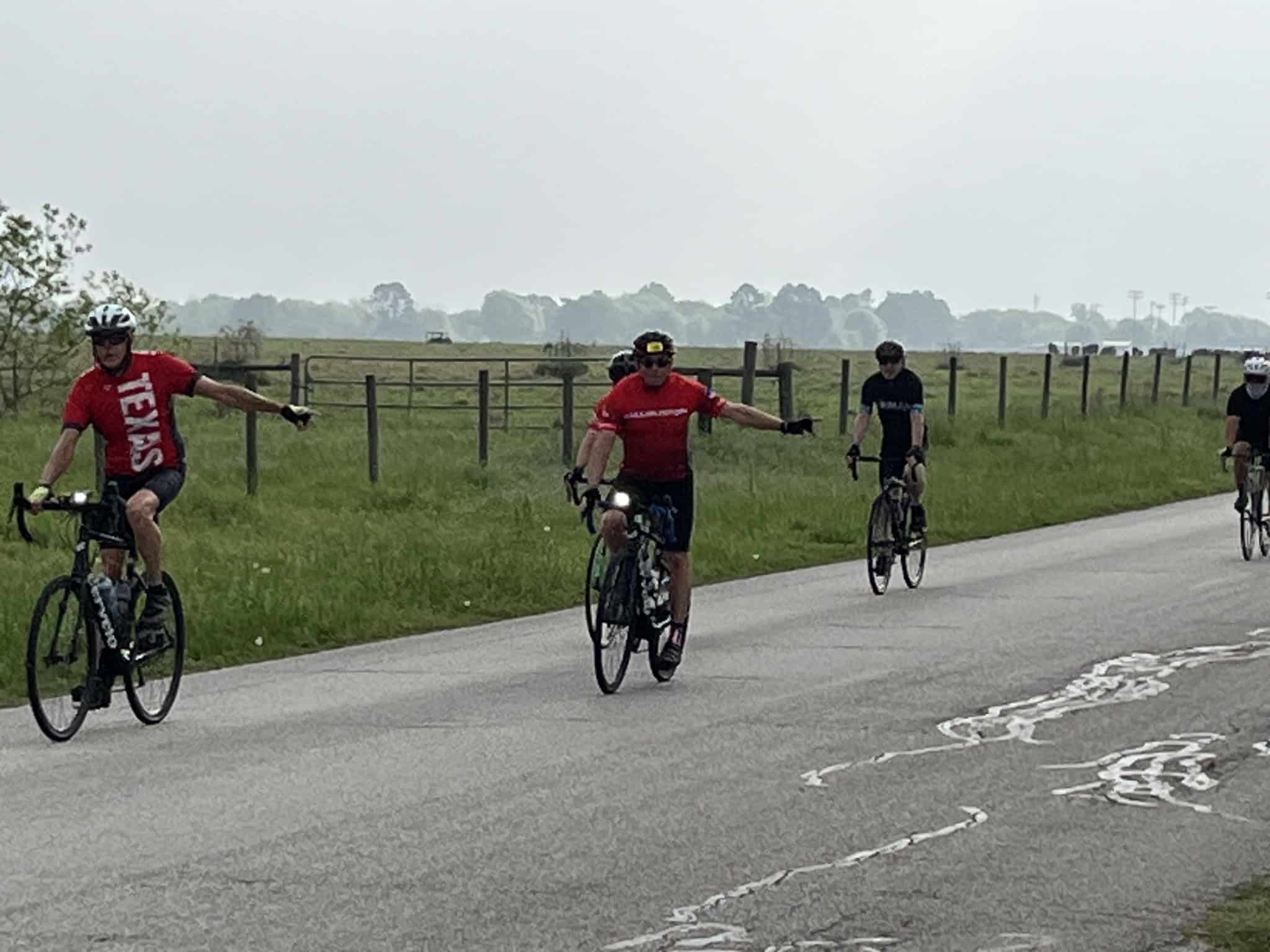 Cyclists riding on scenic Texas highway, enjoying the Bluebonnet Express bike tour.