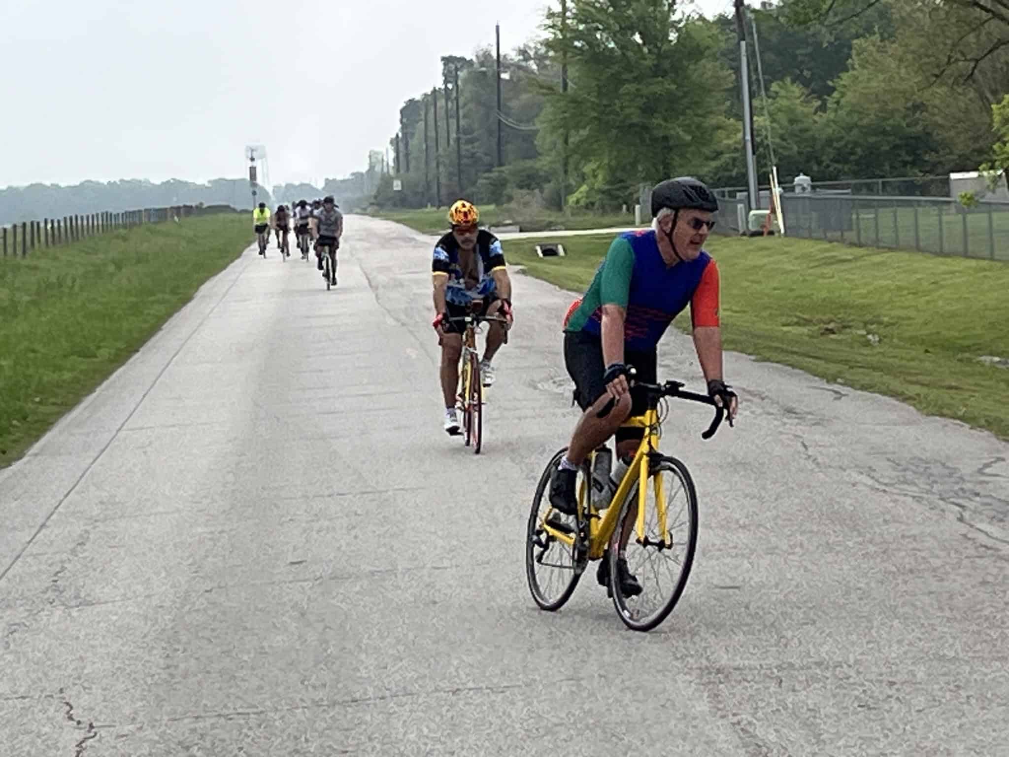 Cyclists riding on a scenic bike trail near Bluebonnet Express, enjoying outdoor biking and nature.