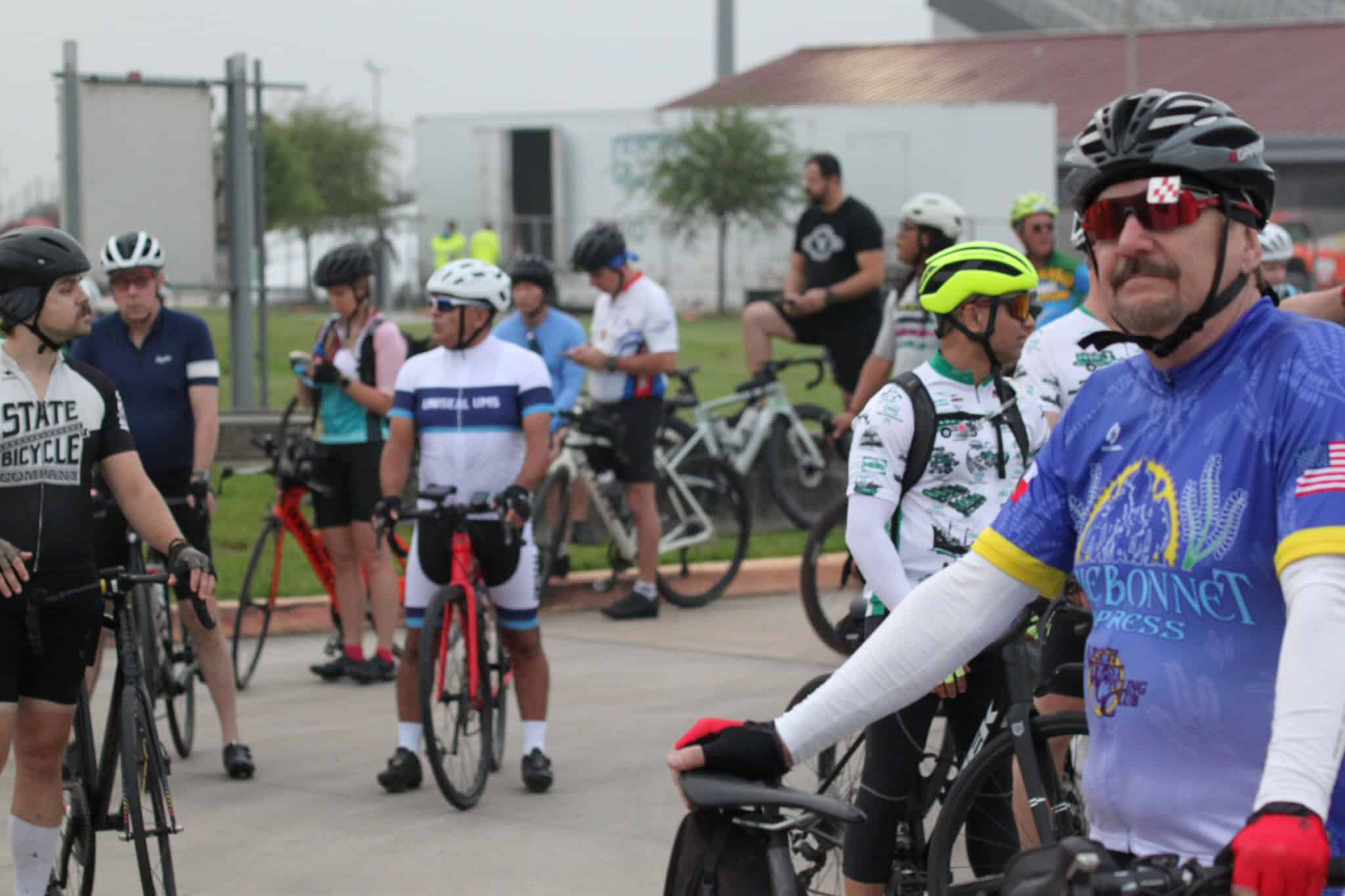 Brightly colored cyclists at Bluebonnet Express bike ride event, preparing for a scenic ride.