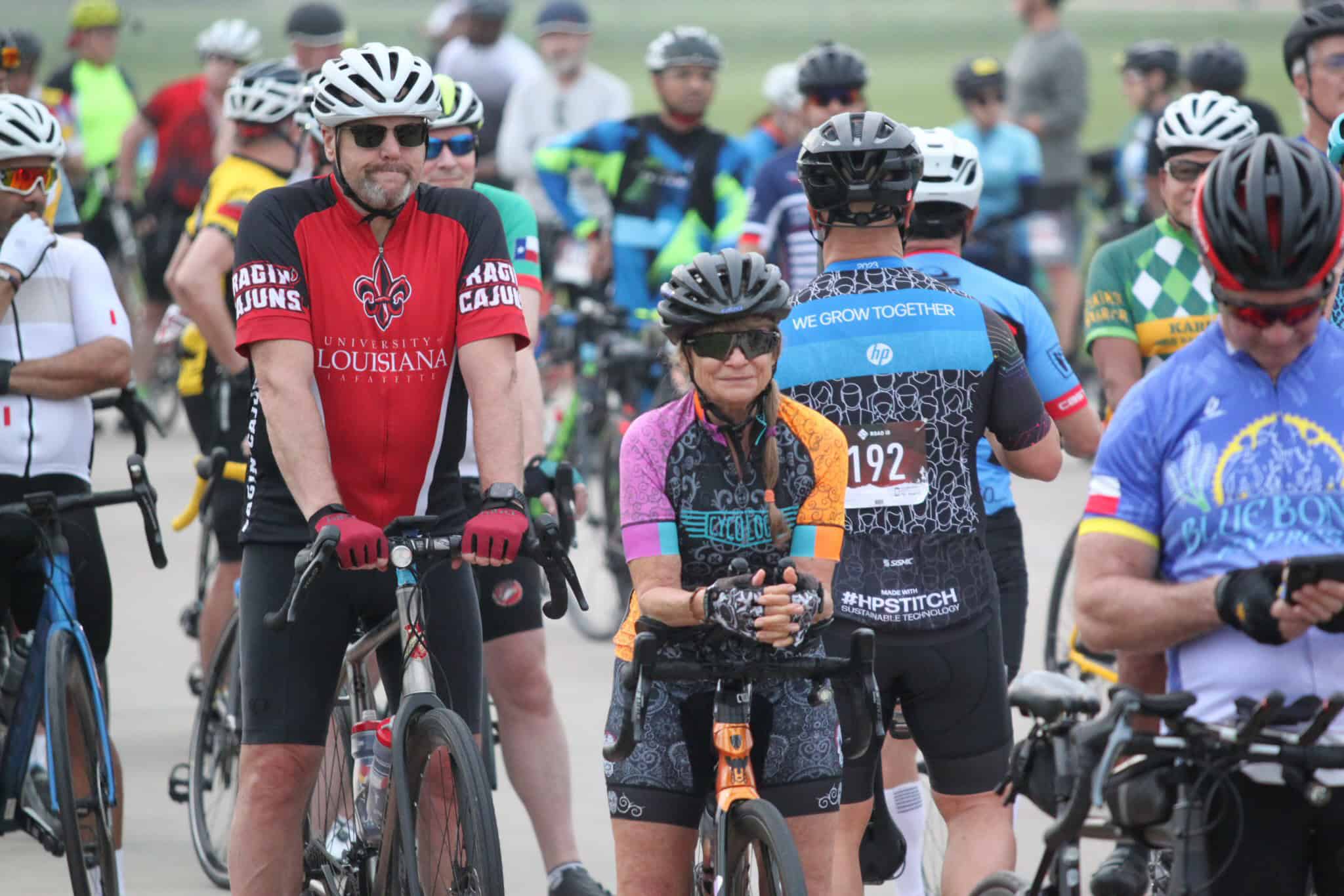 Vibrant group of cyclists at Bluebonnet Express cycling event, showcasing community spirit and bike racing excitement.