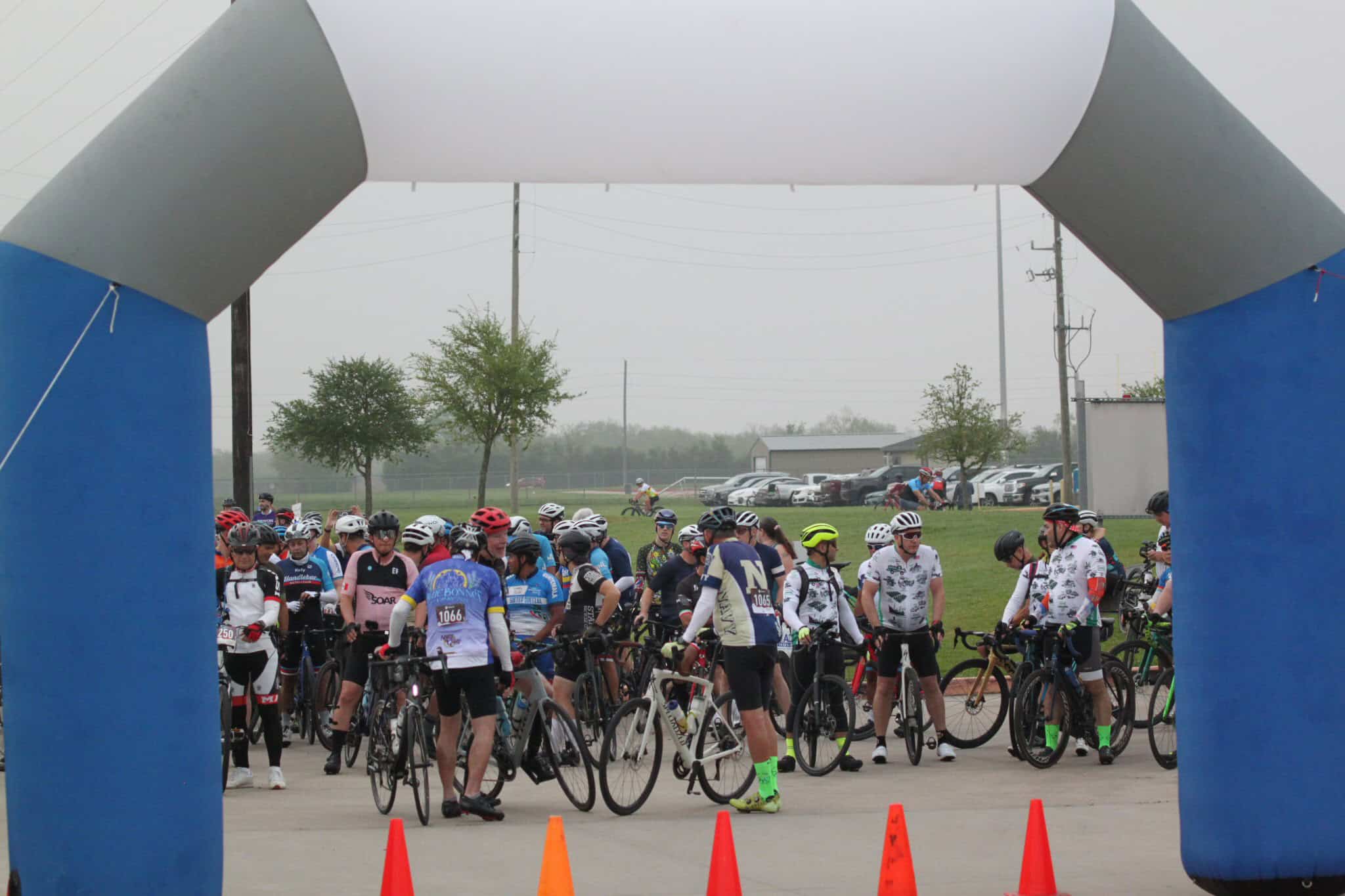 Cyclists gathering at Bluebonnet Express bike race start line, outdoor event for cycling enthusiasts.
