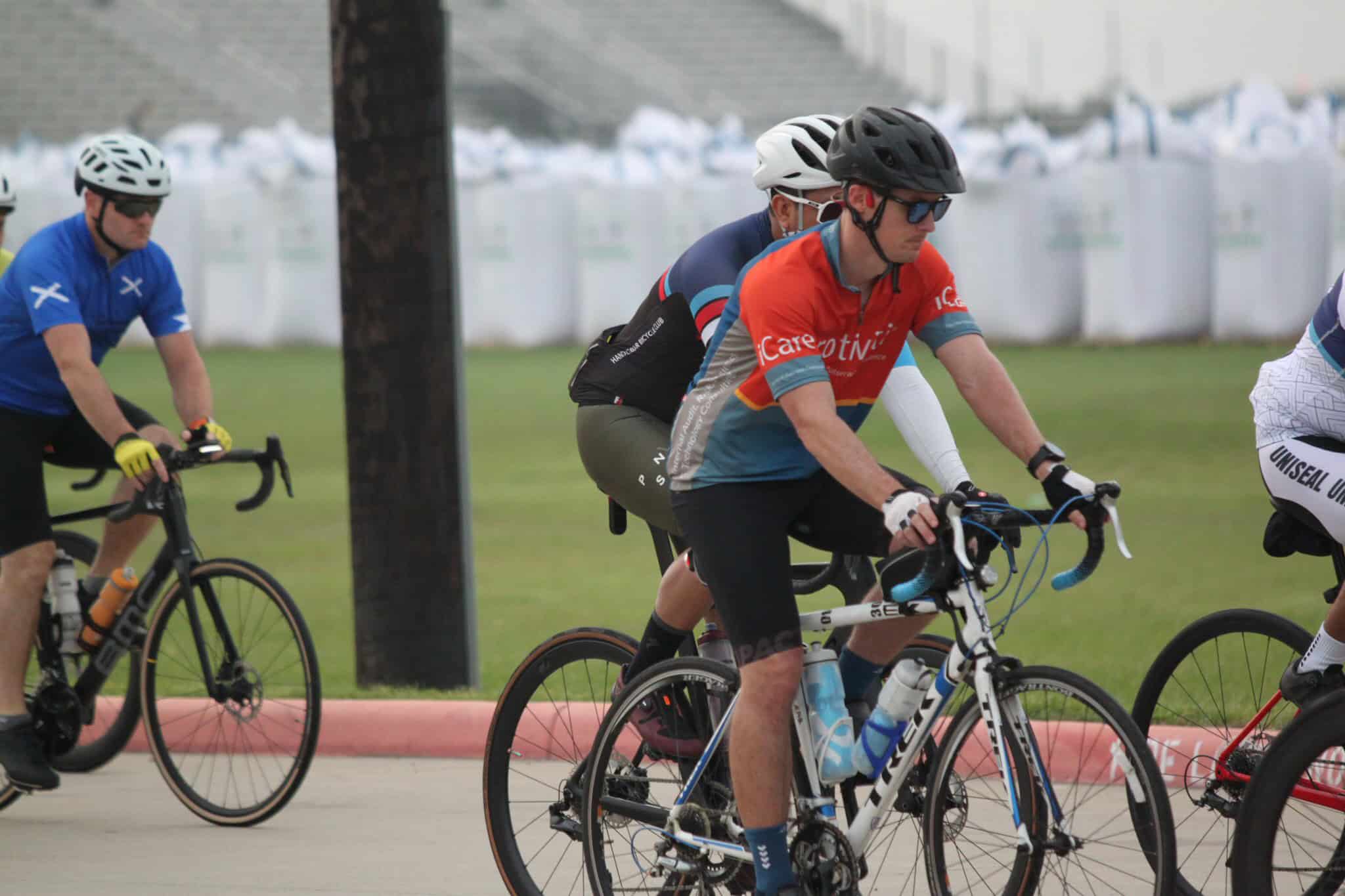 Bright blue and orange cycling team jerseys at Bluebonnet Express bike race event, showcasing competitive mountain biking.