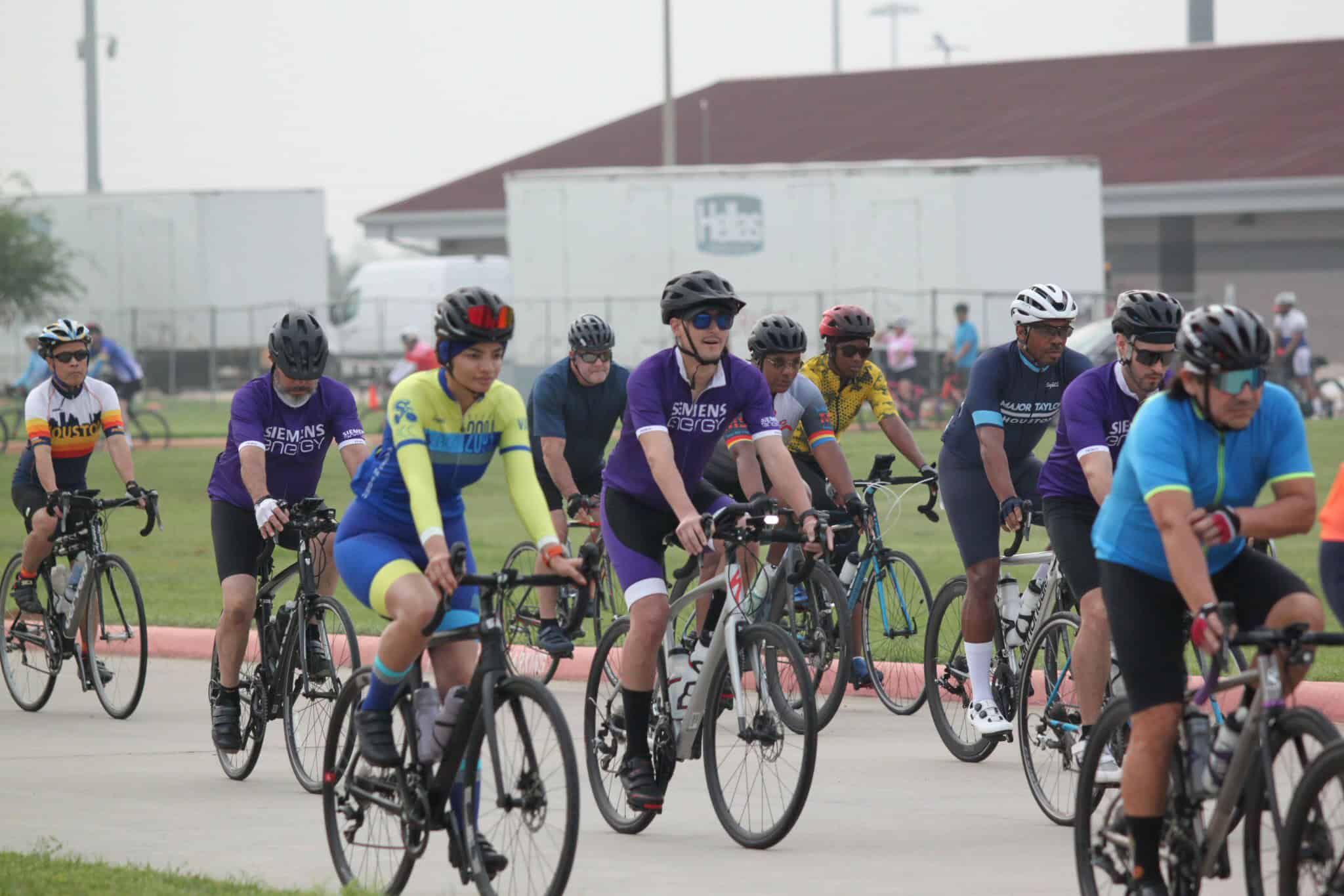 Cyclists riding during Bluebonnet Express cycling event in Texas, promoting fitness and community.