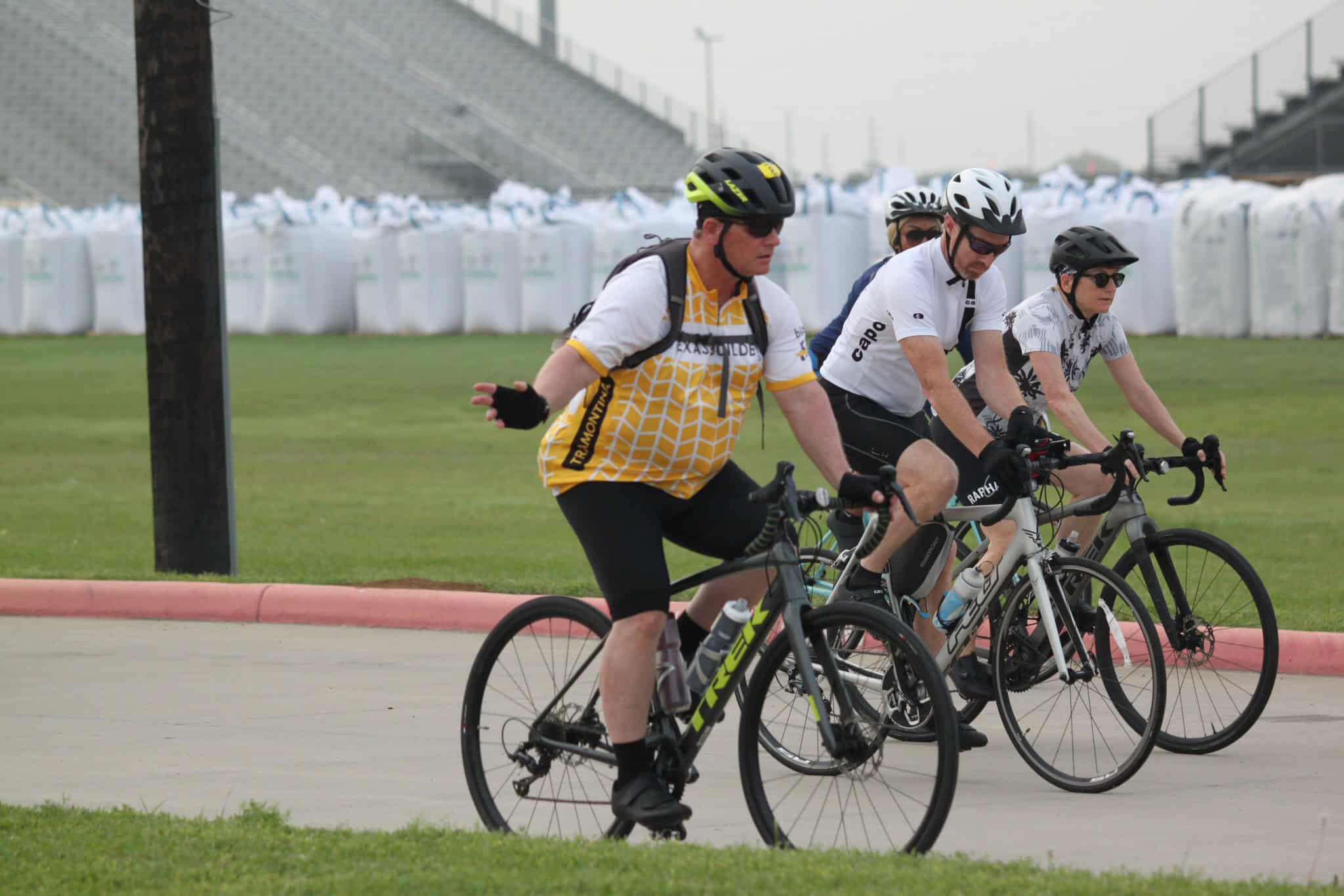 Cyclists riding on a track during Bluebonnet Express event.