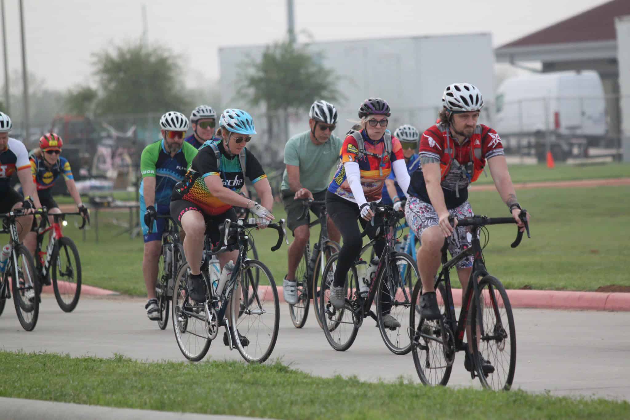 Riders wearing colorful helmets participating in Bluebonnet Express bike event for cycling enthusiasts.