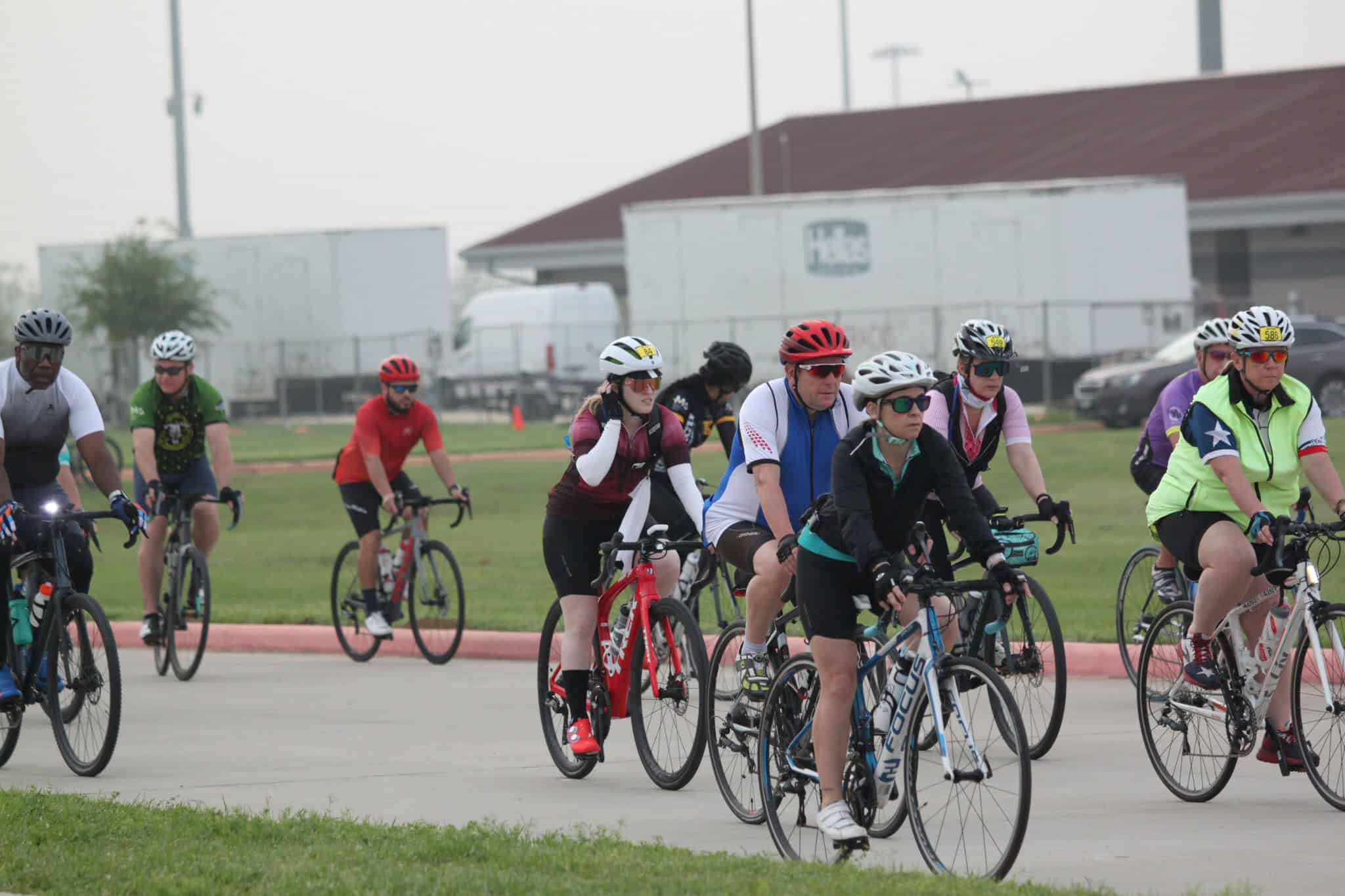 Cyclists riding on a designated bike lane in a group at Bluebonnet Express event.