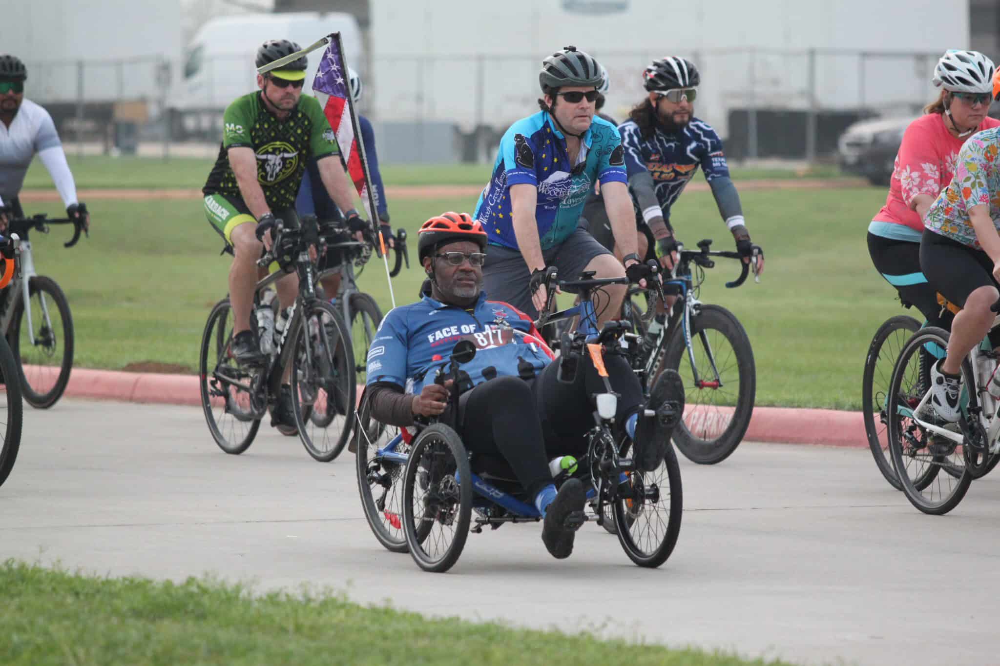 Adaptive cycling event at Bluebonnet Express biking race with diverse participants.