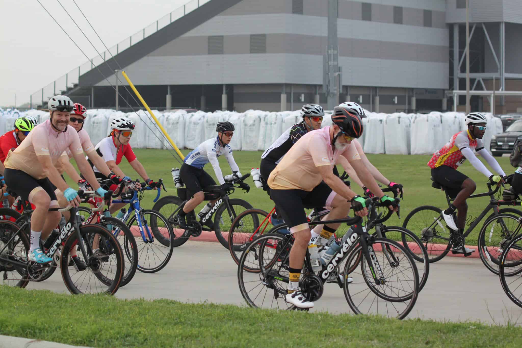 Brightly dressed cyclists participating in Bluebonnet Express bike ride event.