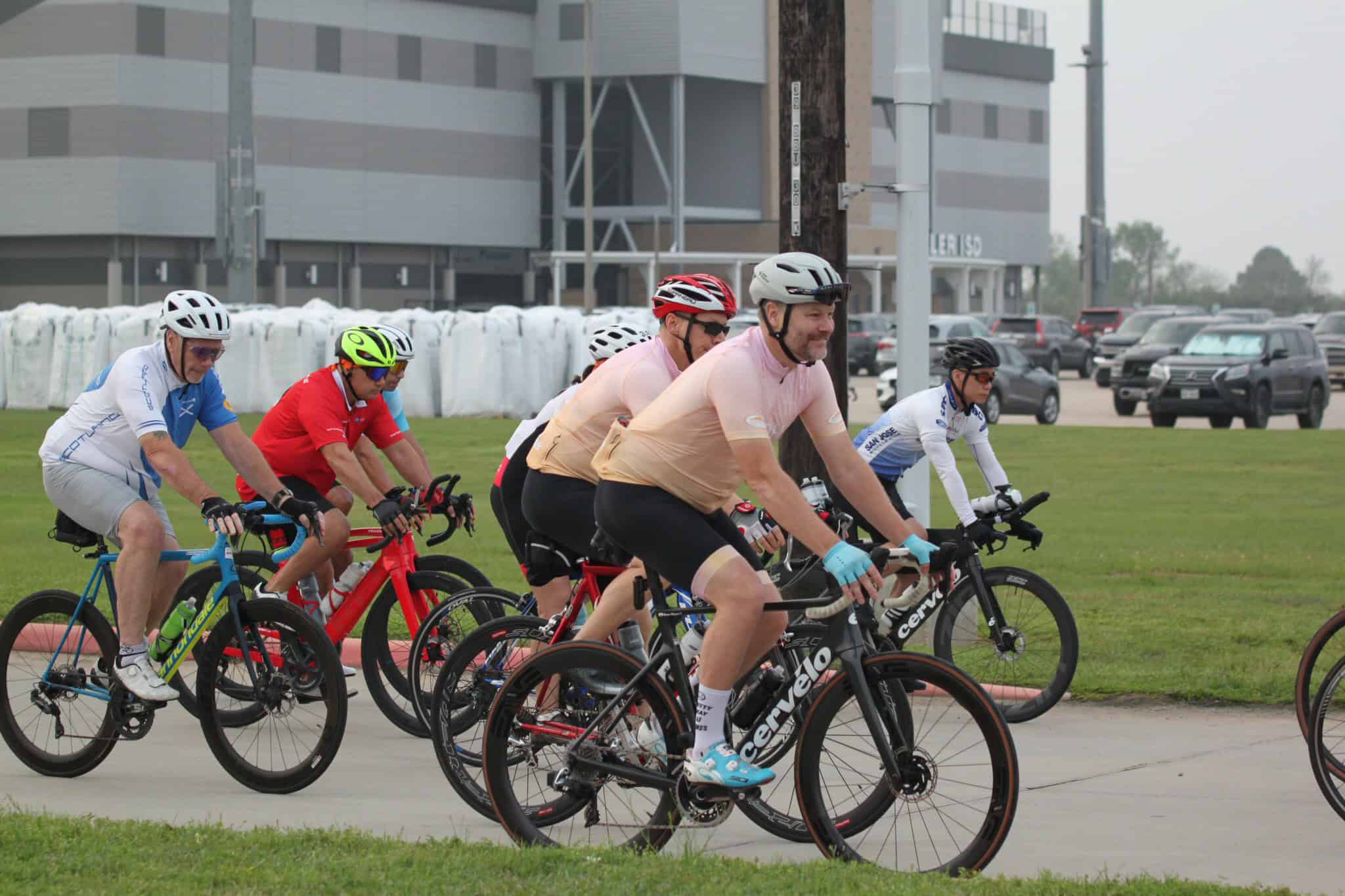Bike riders participating in a cycling event on a city street.