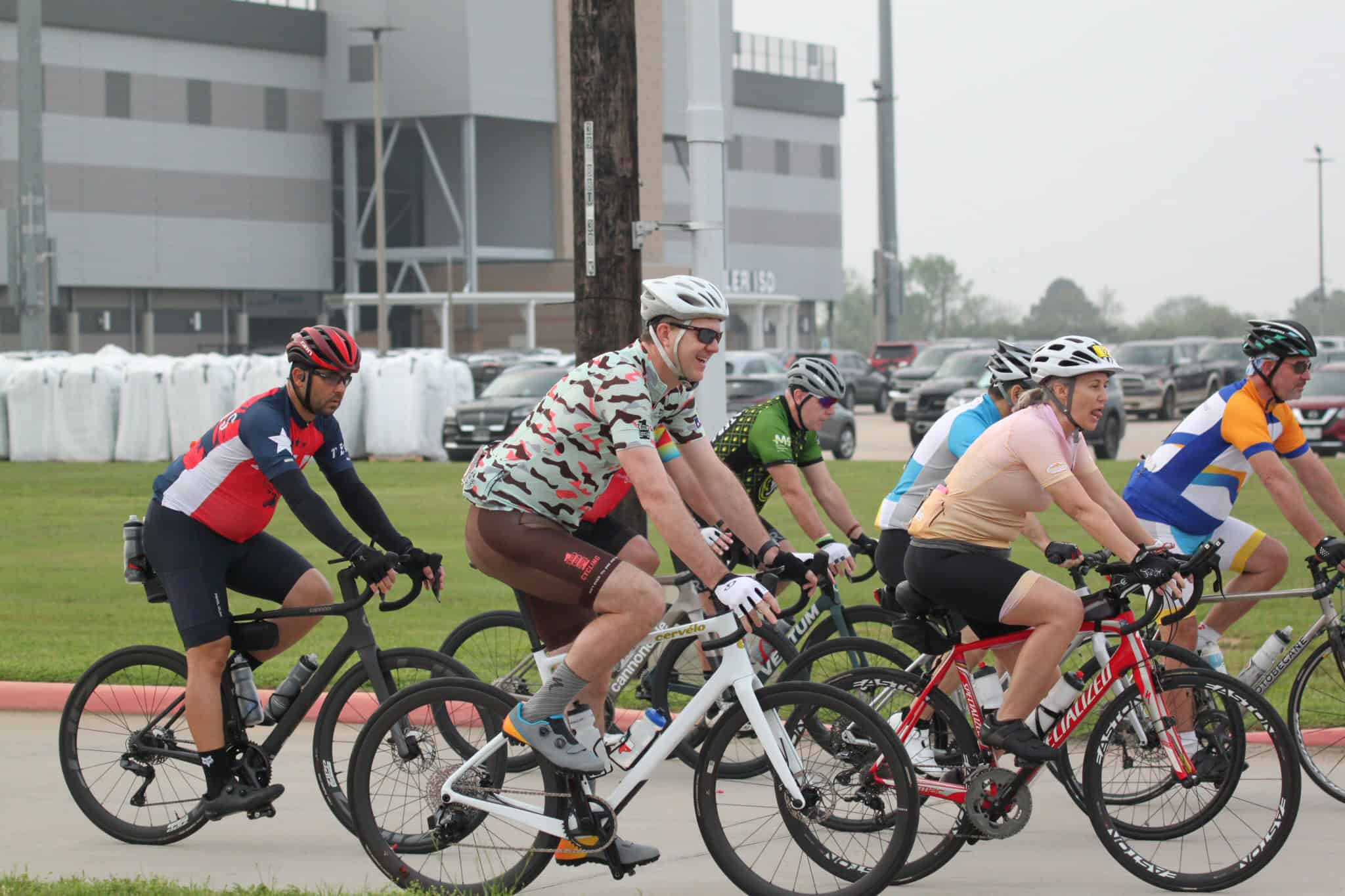 Group of cyclists riding bikes during daytime at Bluebonnet Express event.