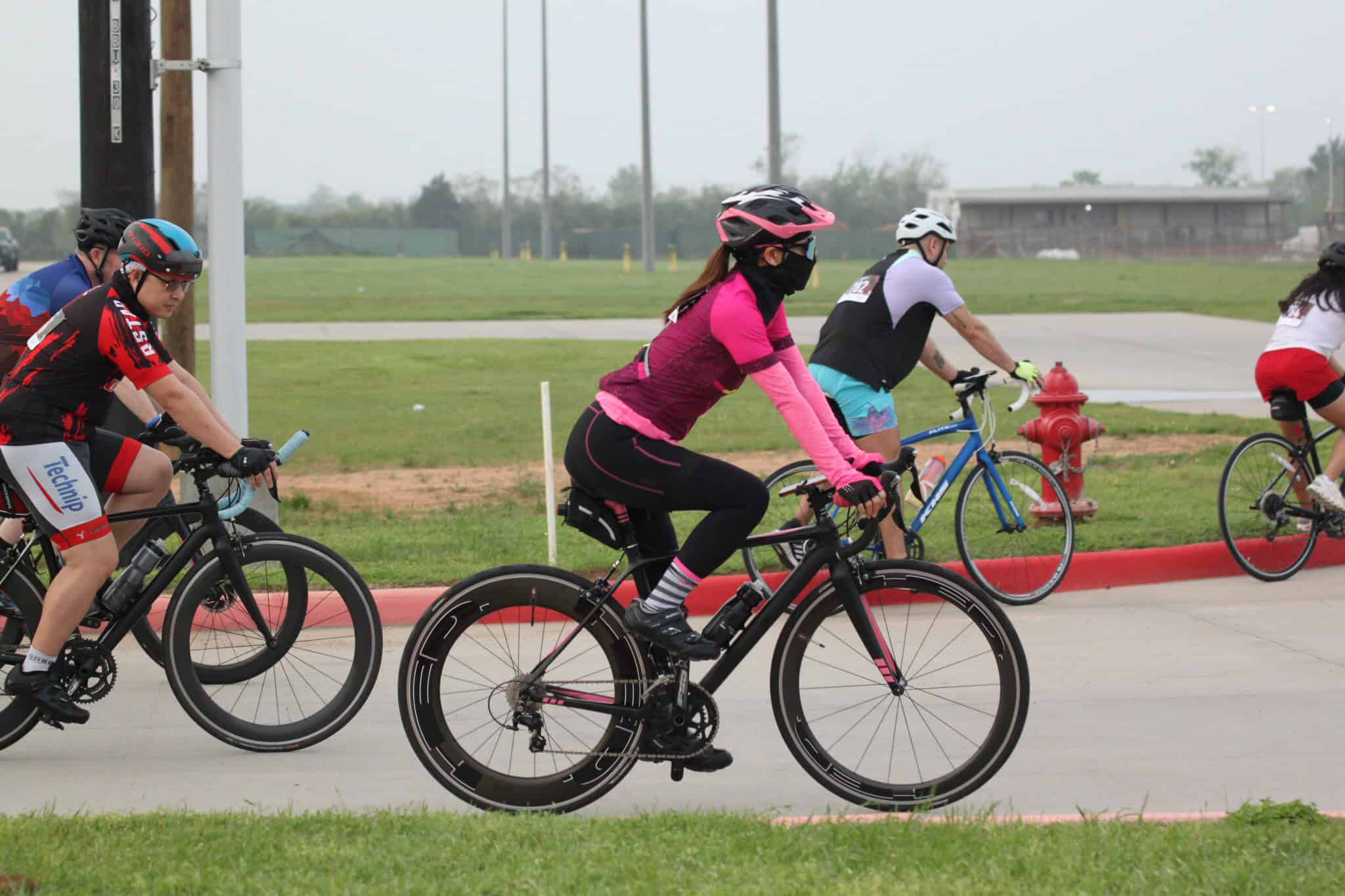 Vibrant group of cyclists riding on a trail, showcasing Bluebonnet Express cycling event and outdoor adventure.