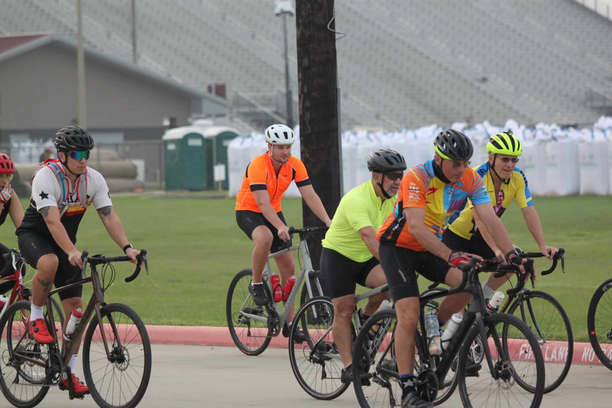 Cyclists participating in Bluebonnet Express bike event during daytime, showcasing active outdoor cycling race.