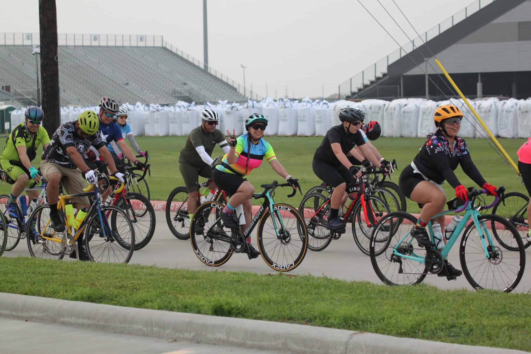 Vibrant group of cyclists participating in Bluebonnet Express bike race on a professional track.