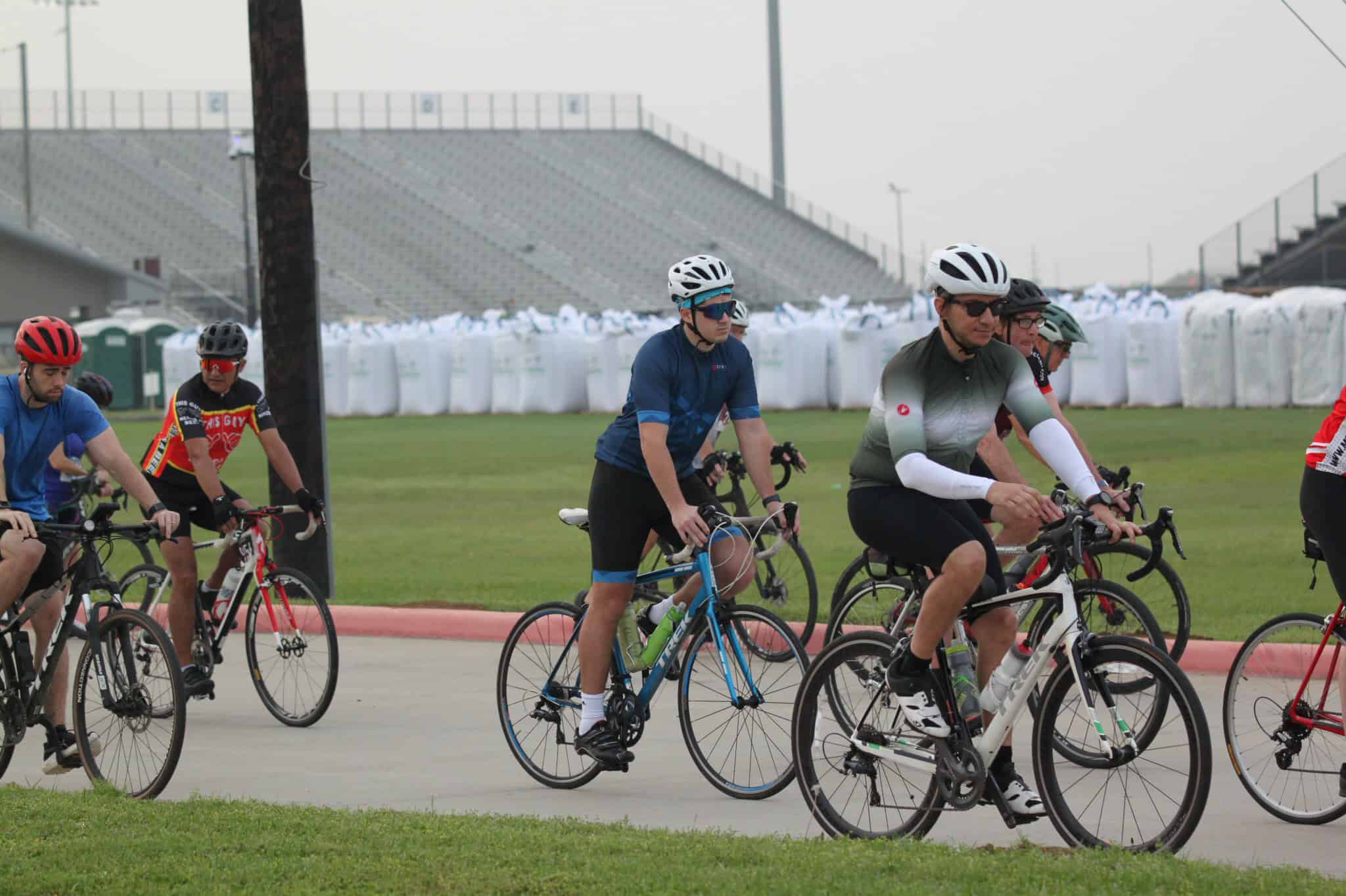 Cyclists riding on a stadium track during the Bluebonnet Express event, promoting cycling and outdoor fitness.