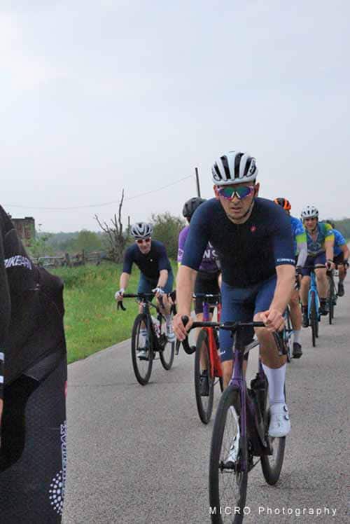 Cyclists riding bikes during Bluebonnet Express event in Texas, promoting fitness and community.