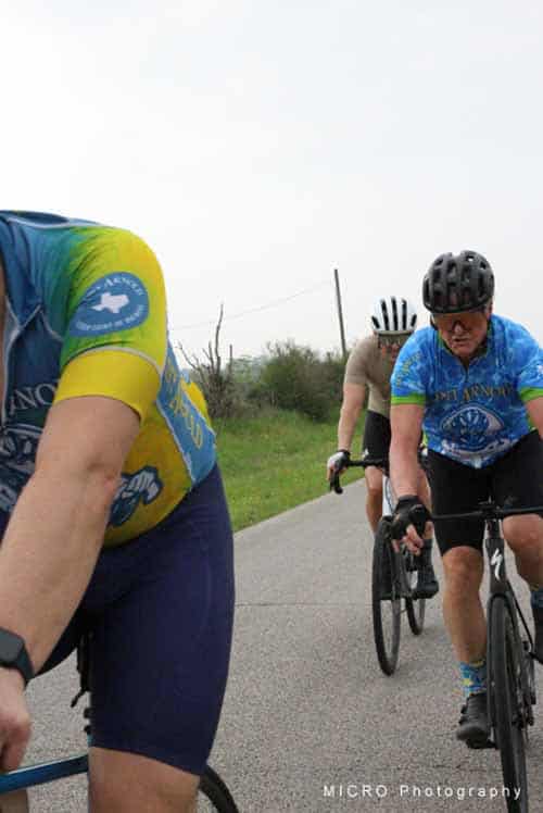 Cyclists riding outdoors during Bluebonnet Express bike event, scenic Texas countryside atmosphere.