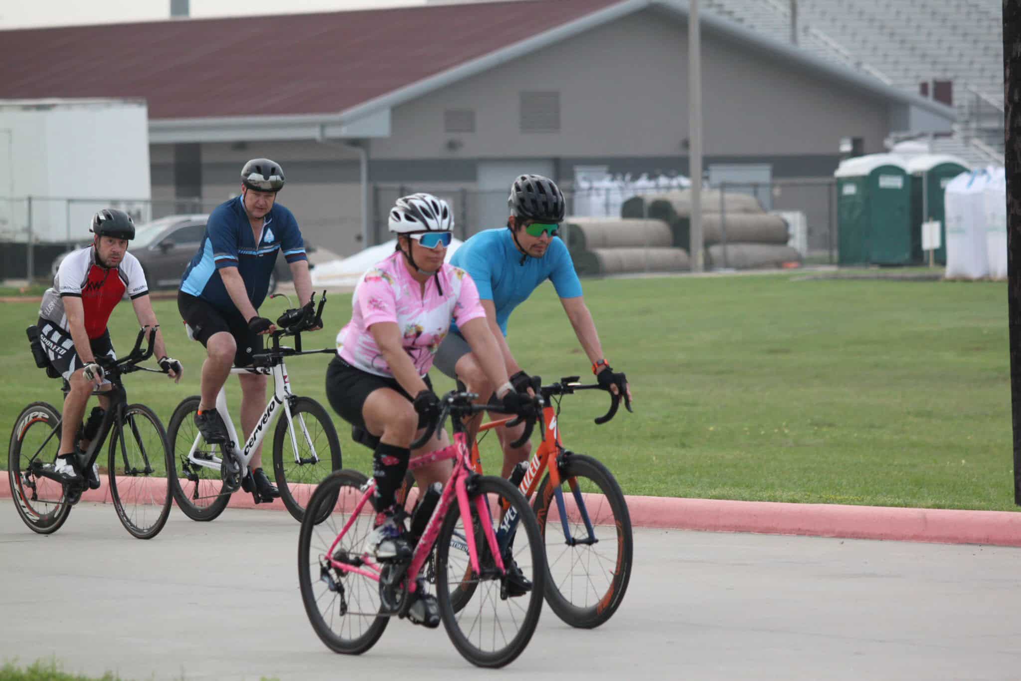 Bike riders on a scenic cycling trail, part of Bluebonnet Express bike tour event.
