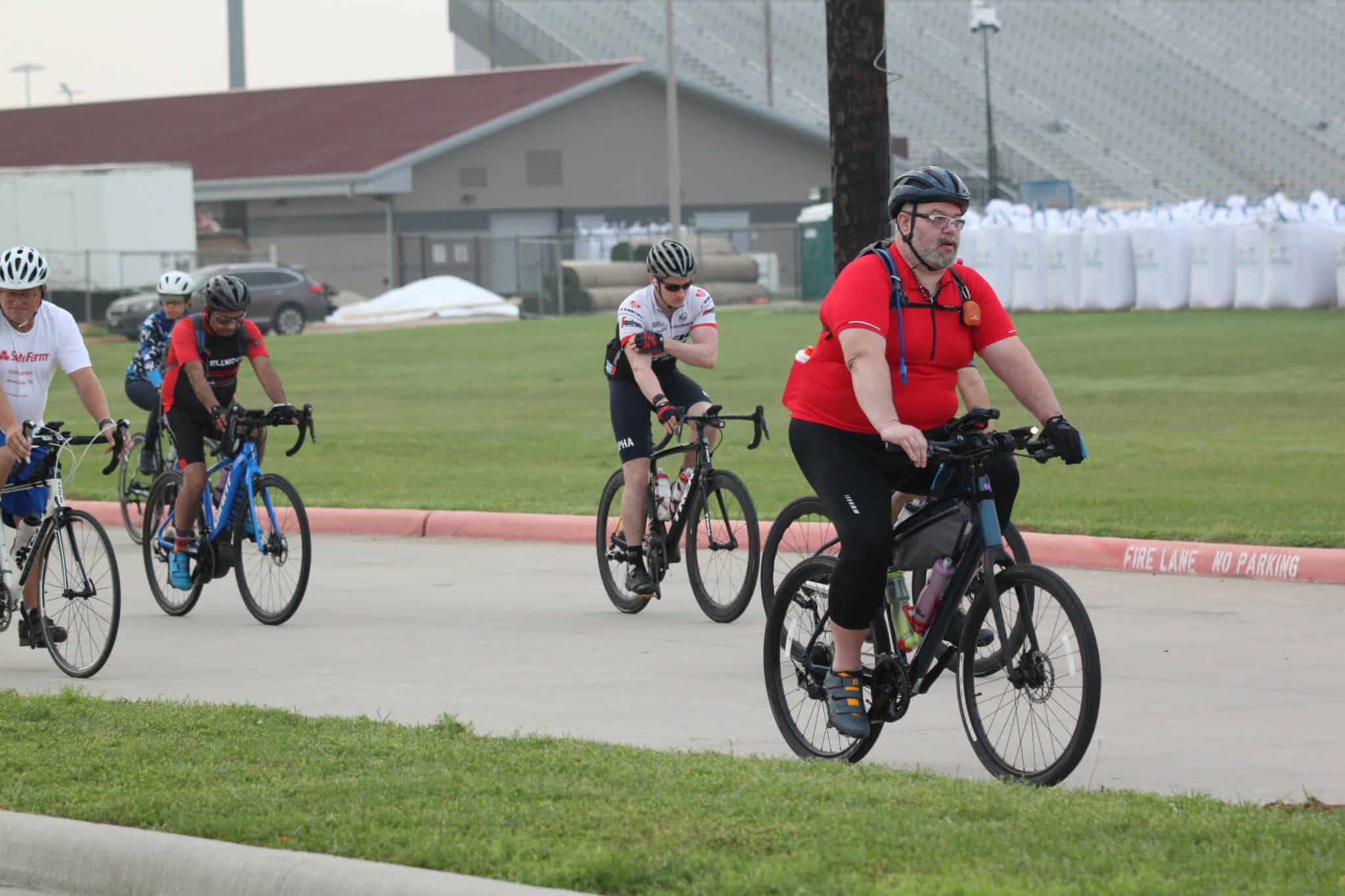 Outdoor group cycling on Bluebonnet Express trail with diverse ridersâhealthy, scenic ride, fitness, outdoor activity, hot weather biking.