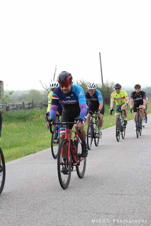 Brightly colored cyclists riding together during Bluebonnet Express cycling event.