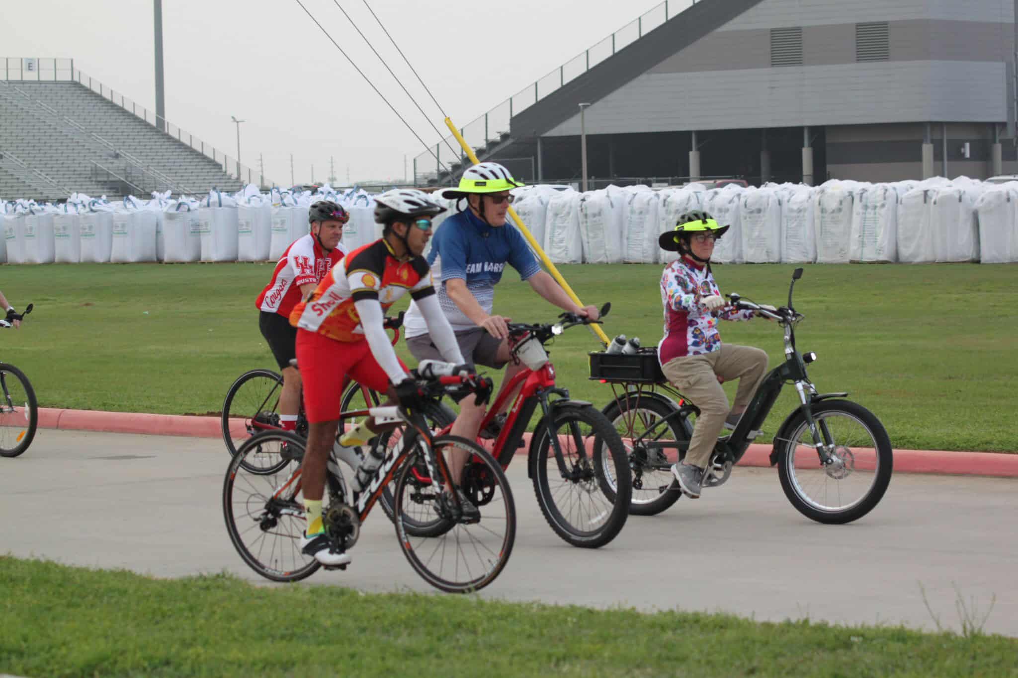 Riders cycling with electric bikes at Bluebonnet Express event, Texas outdoor area.