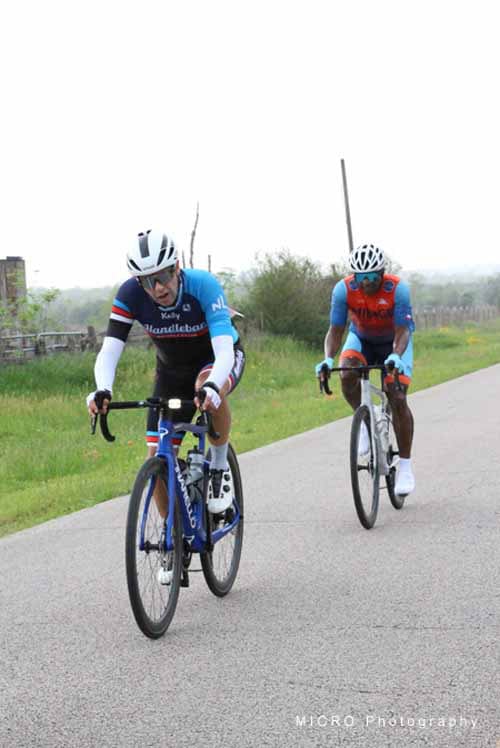 Cyclists riding on a scenic rural road with Bluebonnet Express branding.