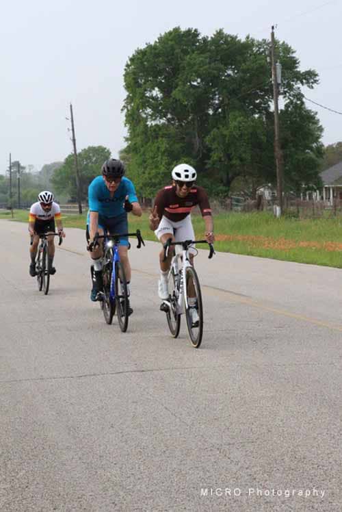 1. Cyclists riding on the road during Bluebonnet Express event, enjoying outdoor biking.