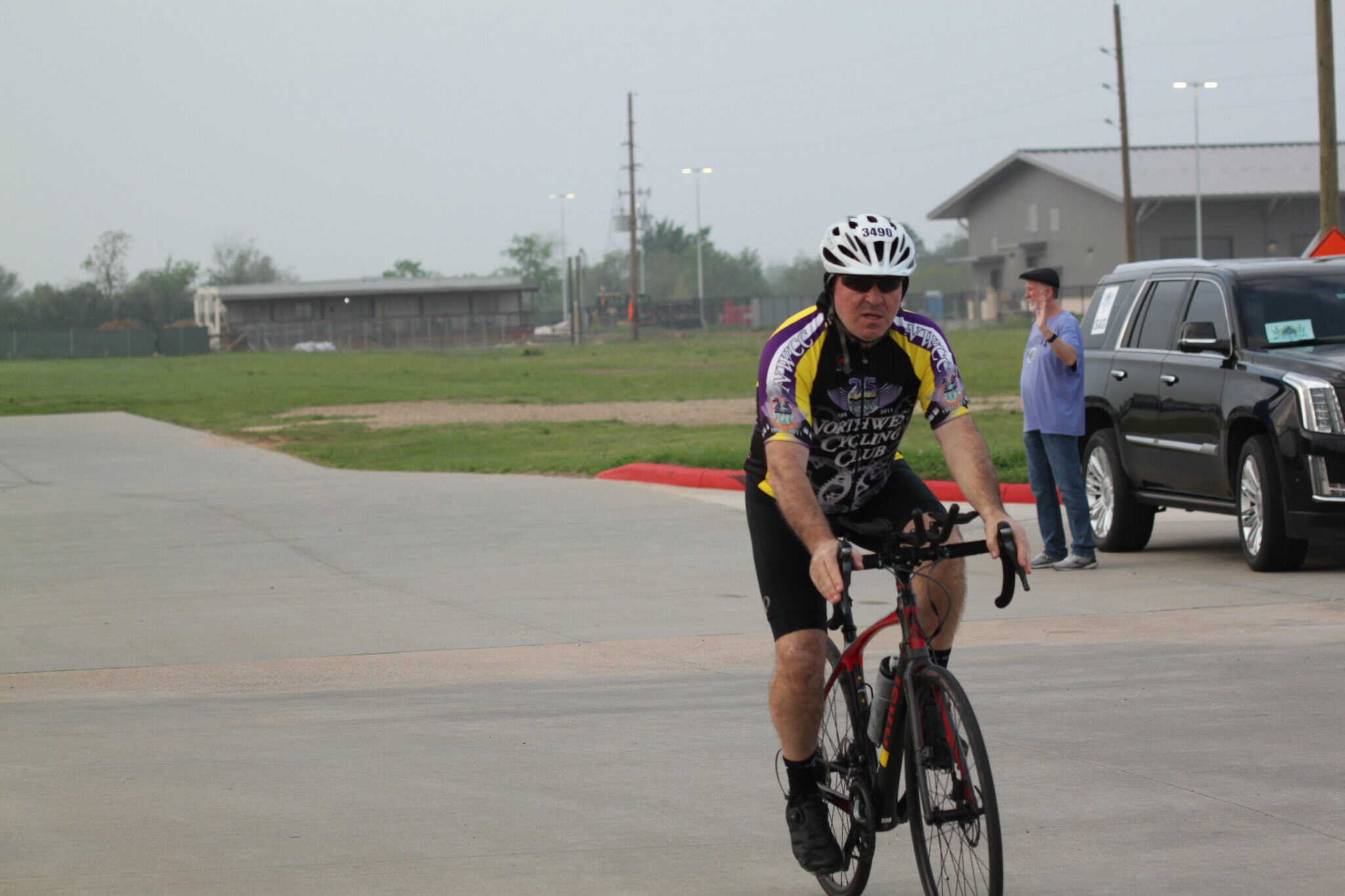 Bike rider participating in Bluebonnet Express cycling event on a paved road.