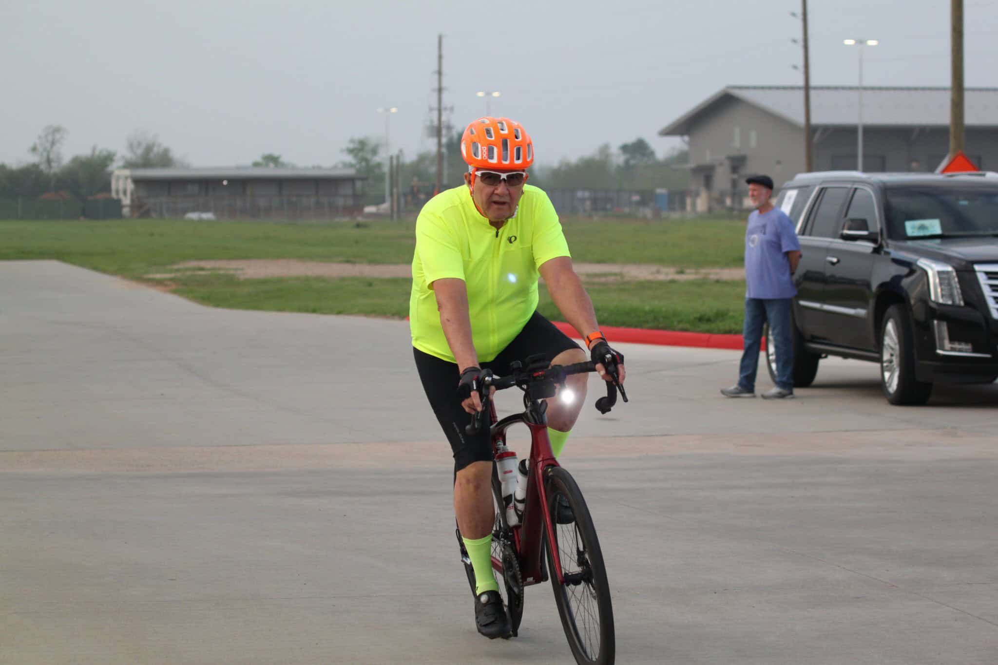 Rider in neon cycling gear on Bluebonnet Express bike trail, enjoying outdoor cycling adventure.