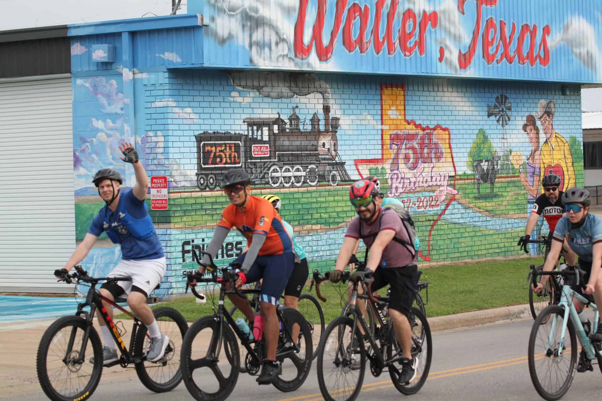 Vibrant mural celebrating Water, Texas and the 75th birthday of the town, featuring a steam locomotive and local characters.