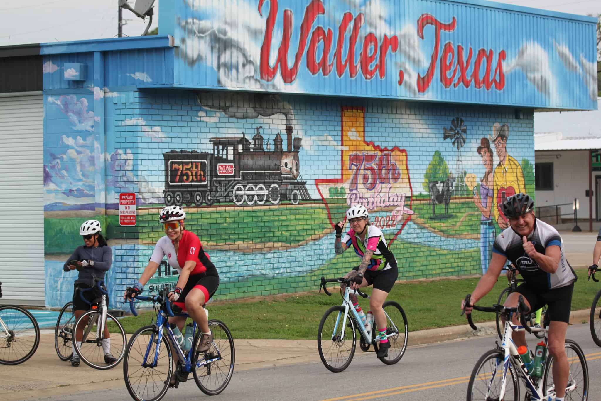 Colorful mural celebrating Walker, Texas 75th anniversary, featuring a steam locomotive and local scenery.