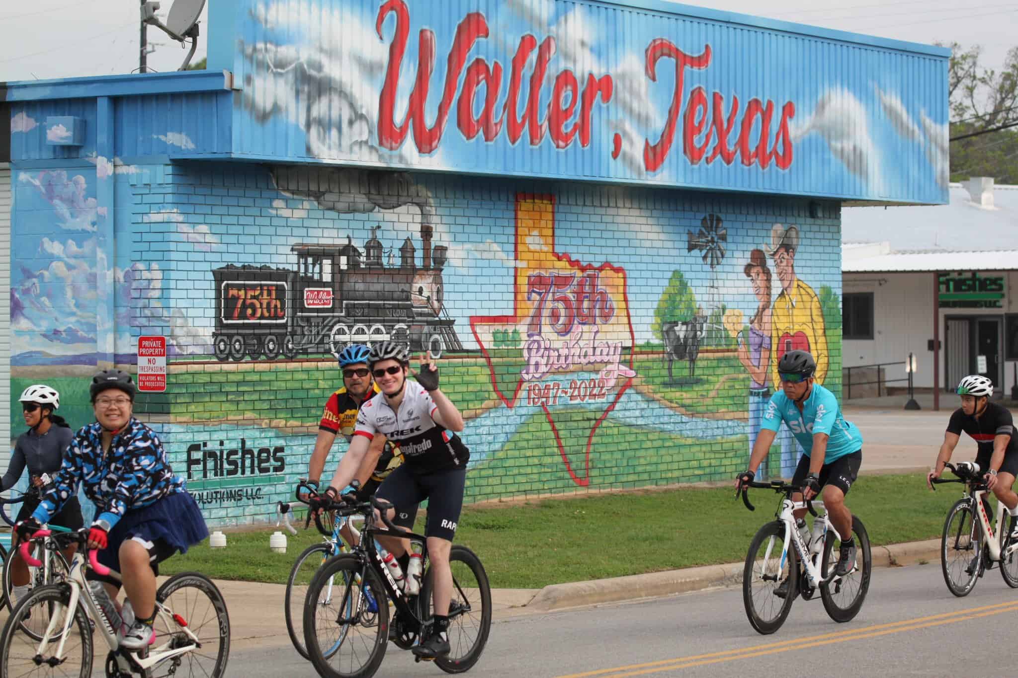 Colorful mural celebrating Waller, Texas 75th anniversary on building wall.