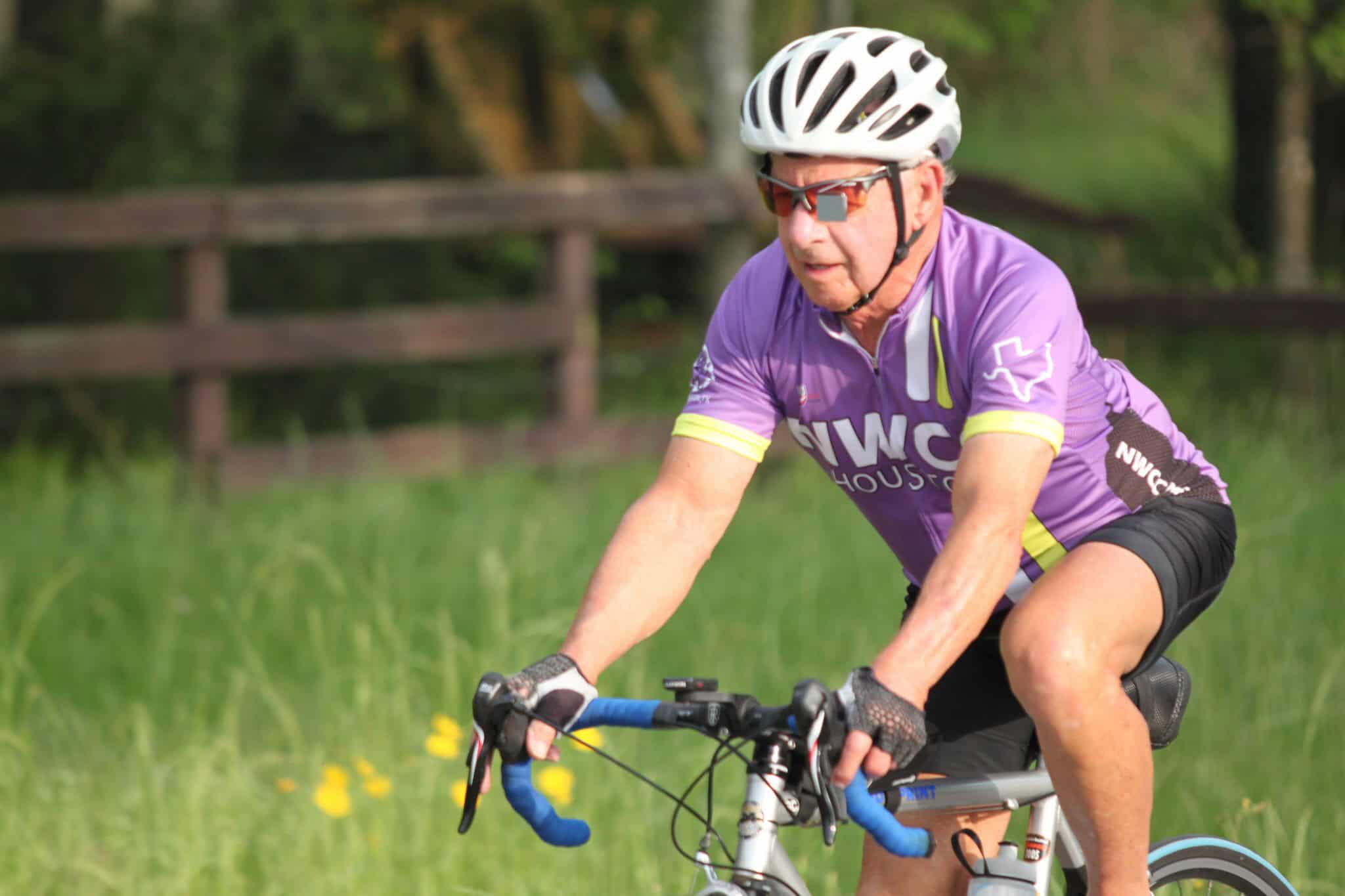 Bright senior cyclist riding on a scenic trail, promoting outdoor fitness and active lifestyle.