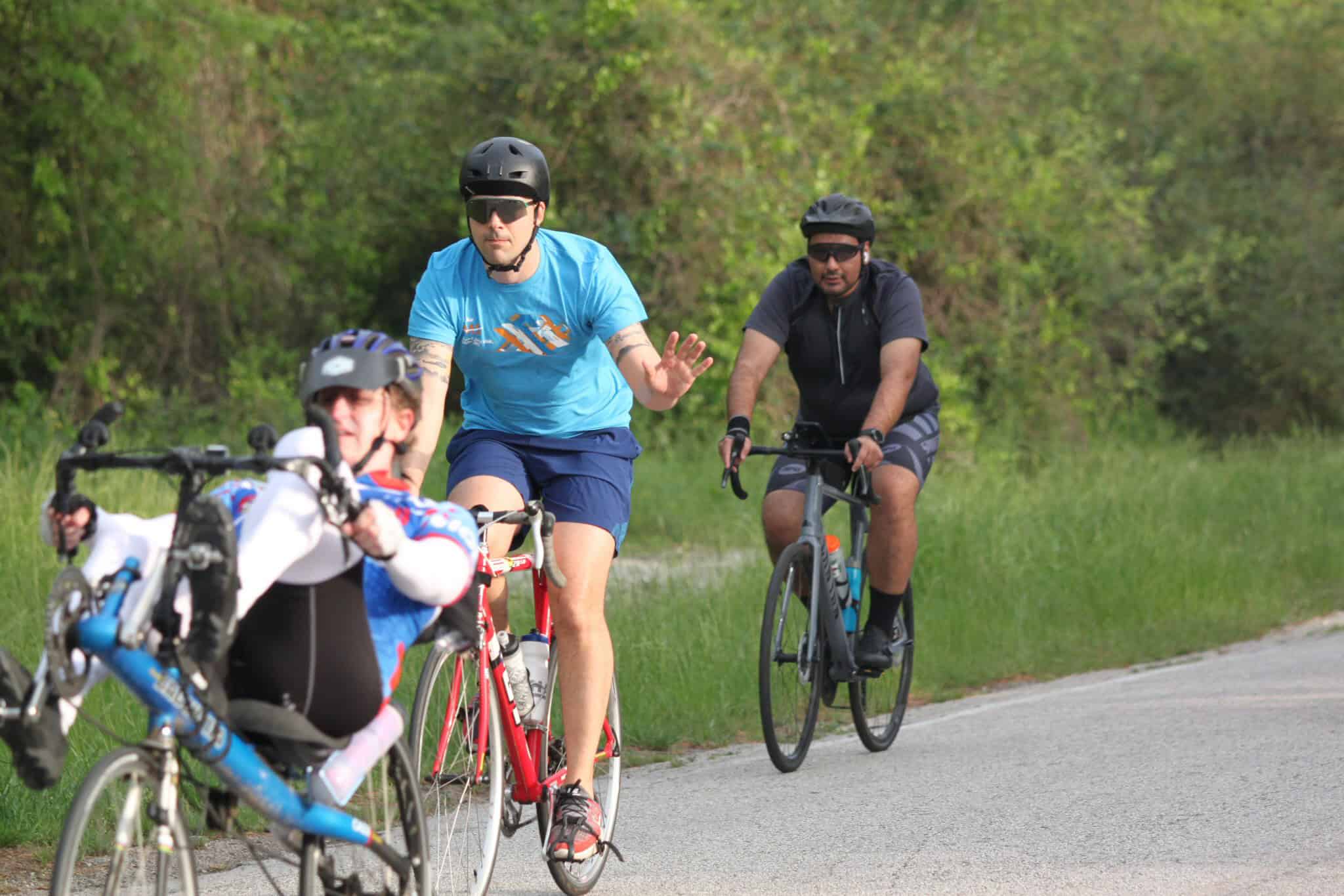 Cyclists riding mountain bikes on a scenic trail in nature.