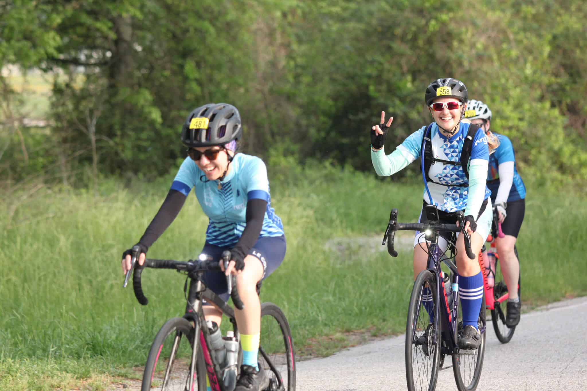 Bright female cyclists enjoying a scenic ride on the Bluebonnet Express bike trail in Texas.