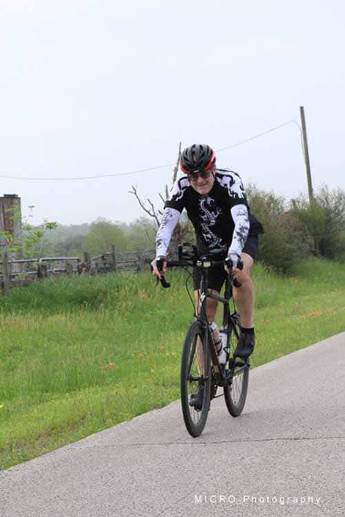 Bright bluebonnet express bicycle on scenic rural trail with cyclist enjoying outdoor adventure.