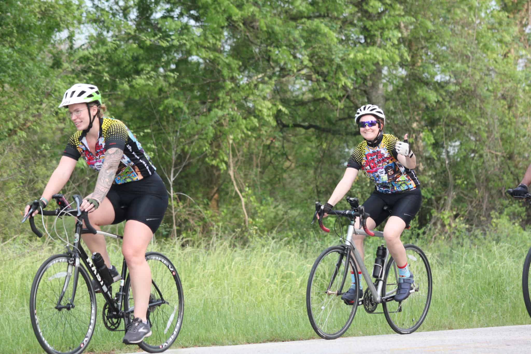 Vegan cyclists riding on a scenic trail during the Bluebonnet Express event.