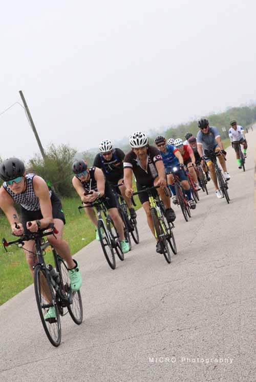 Riders participating in the Bluebonnet Express cycling event on an open road.