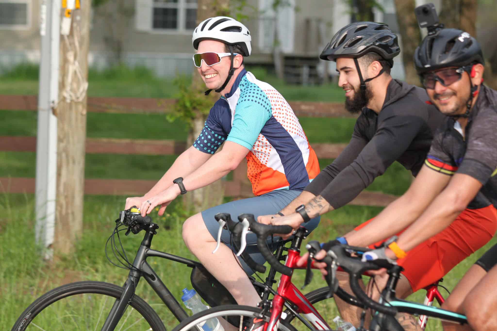 Brightly colored cyclists enjoying a scenic ride on Bluebonnet Express trails.