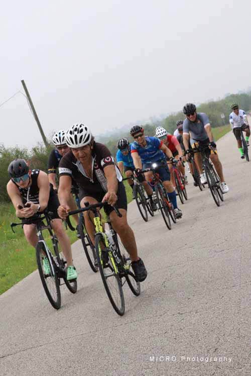 Cyclists riding together on a rural road during Bluebonnet Express event, showcasing group cycling fun.