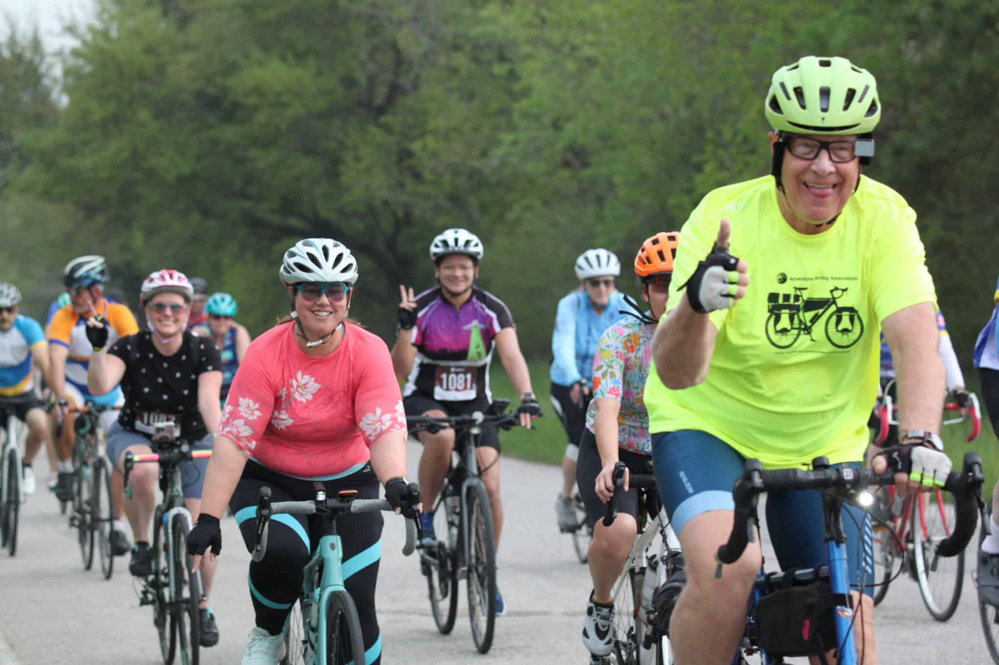 Brightly colored cyclist group participating in Bluebonnet Express bike ride event.
