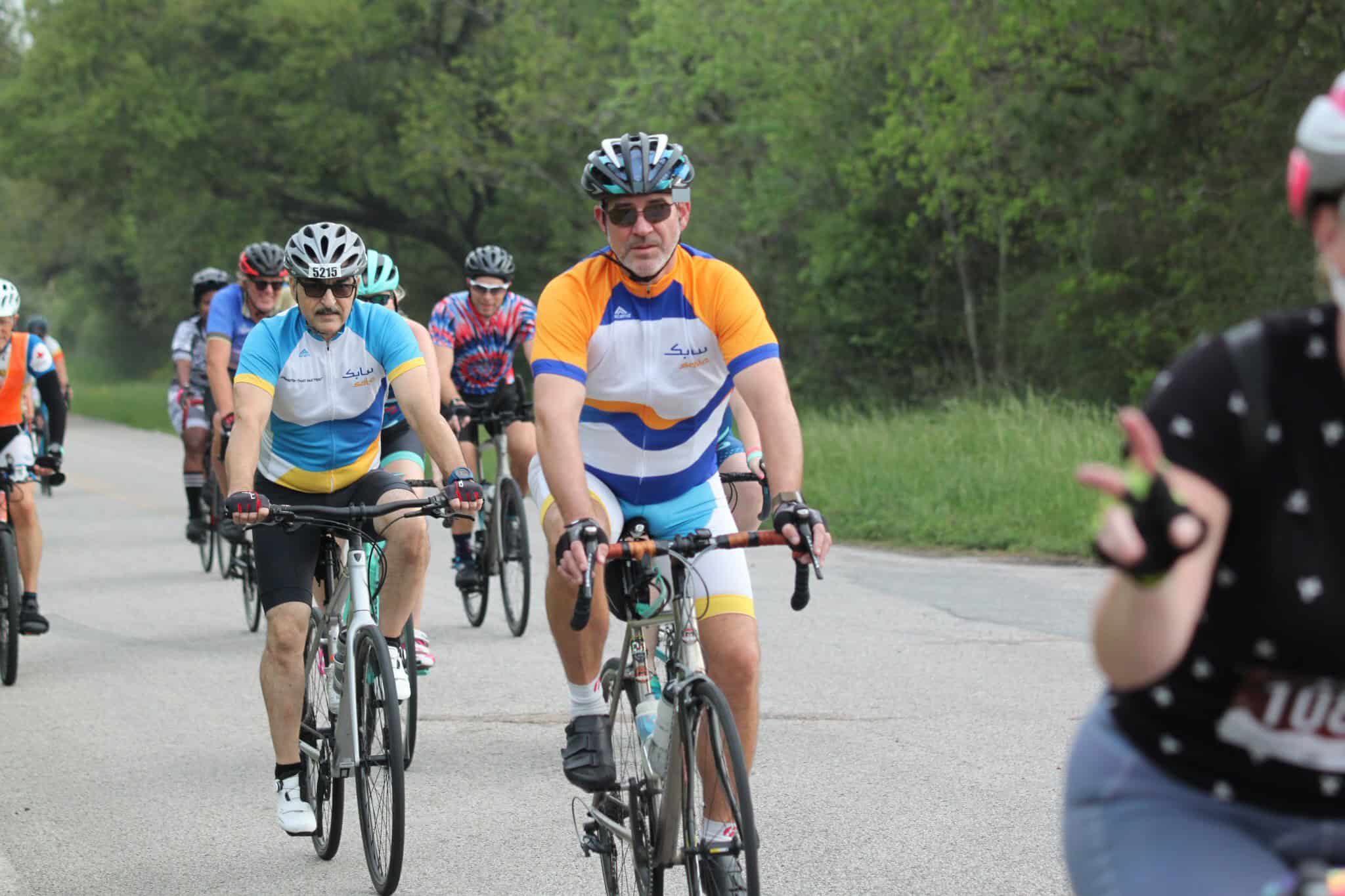 Vibrant cyclists participating in Bluebonnet Express bike race in scenic outdoor setting.