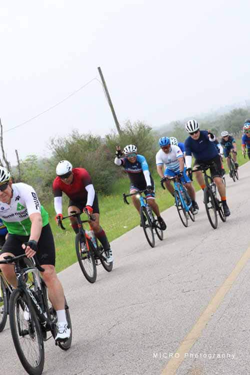 Cyclists riding on a scenic road during Bluebonnet Express bike event in Texas.