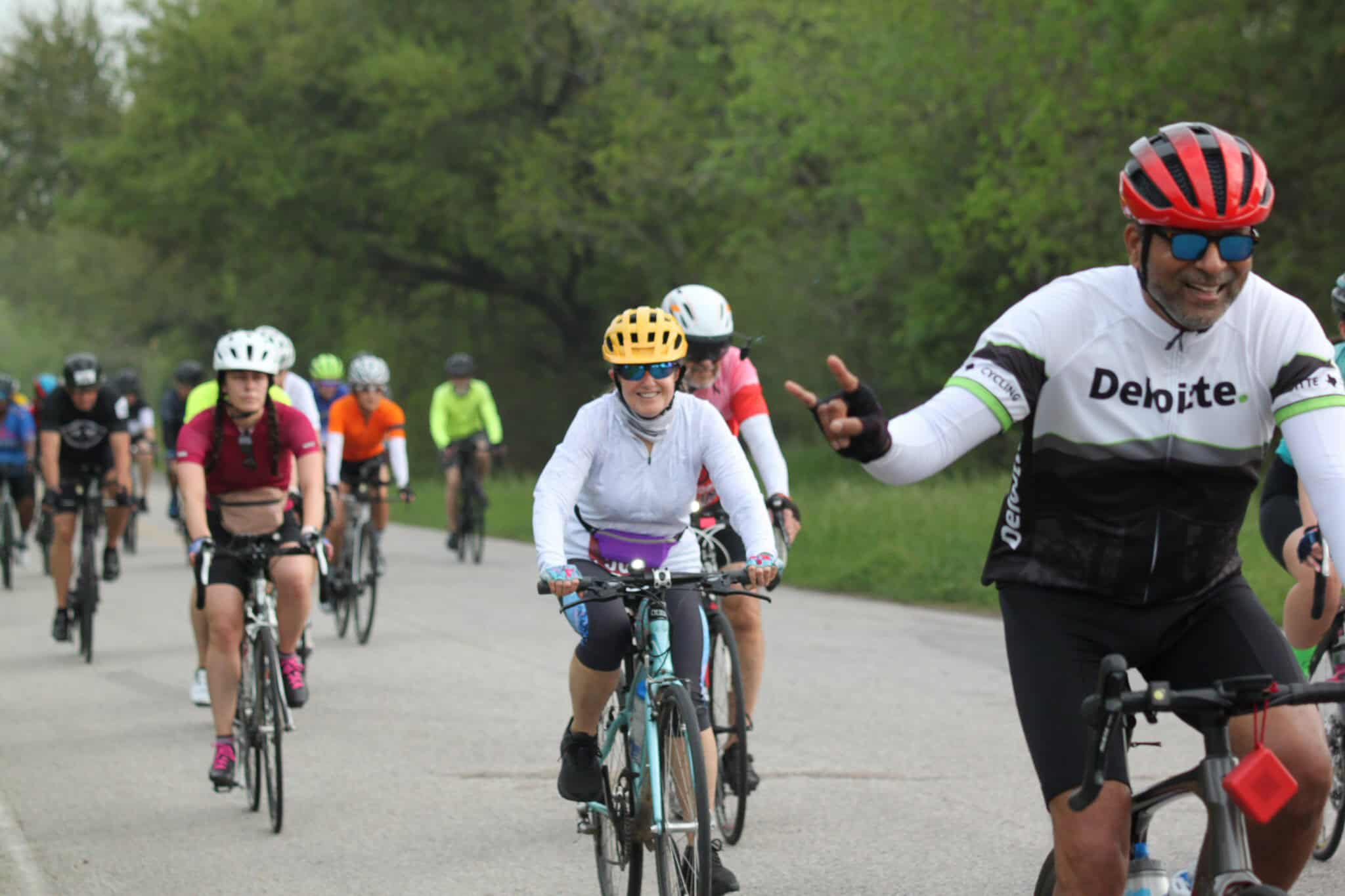 Cyclists enjoying Bluebonnet Express bike ride event on scenic trail.