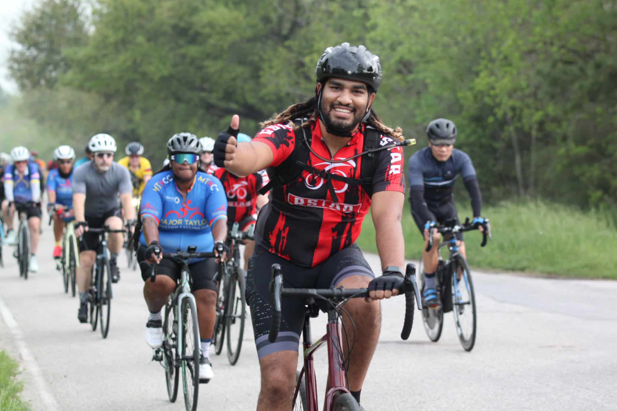 Vibrant group of cyclists participating in Bluebonnet Express bike ride, promoting health and community engagement.