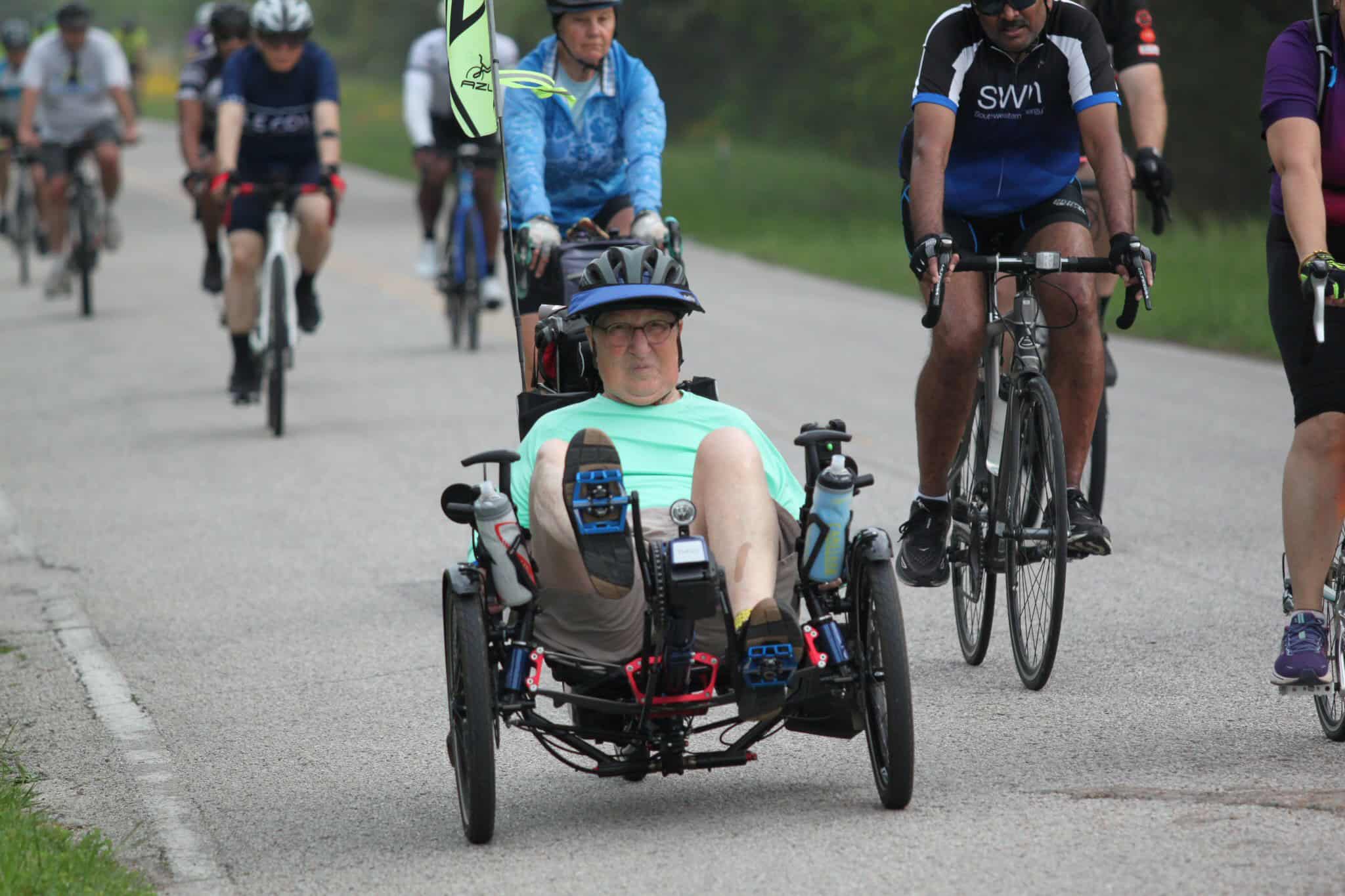 Accessible cycling with adaptive tricycle at Bluebonnet Express event.