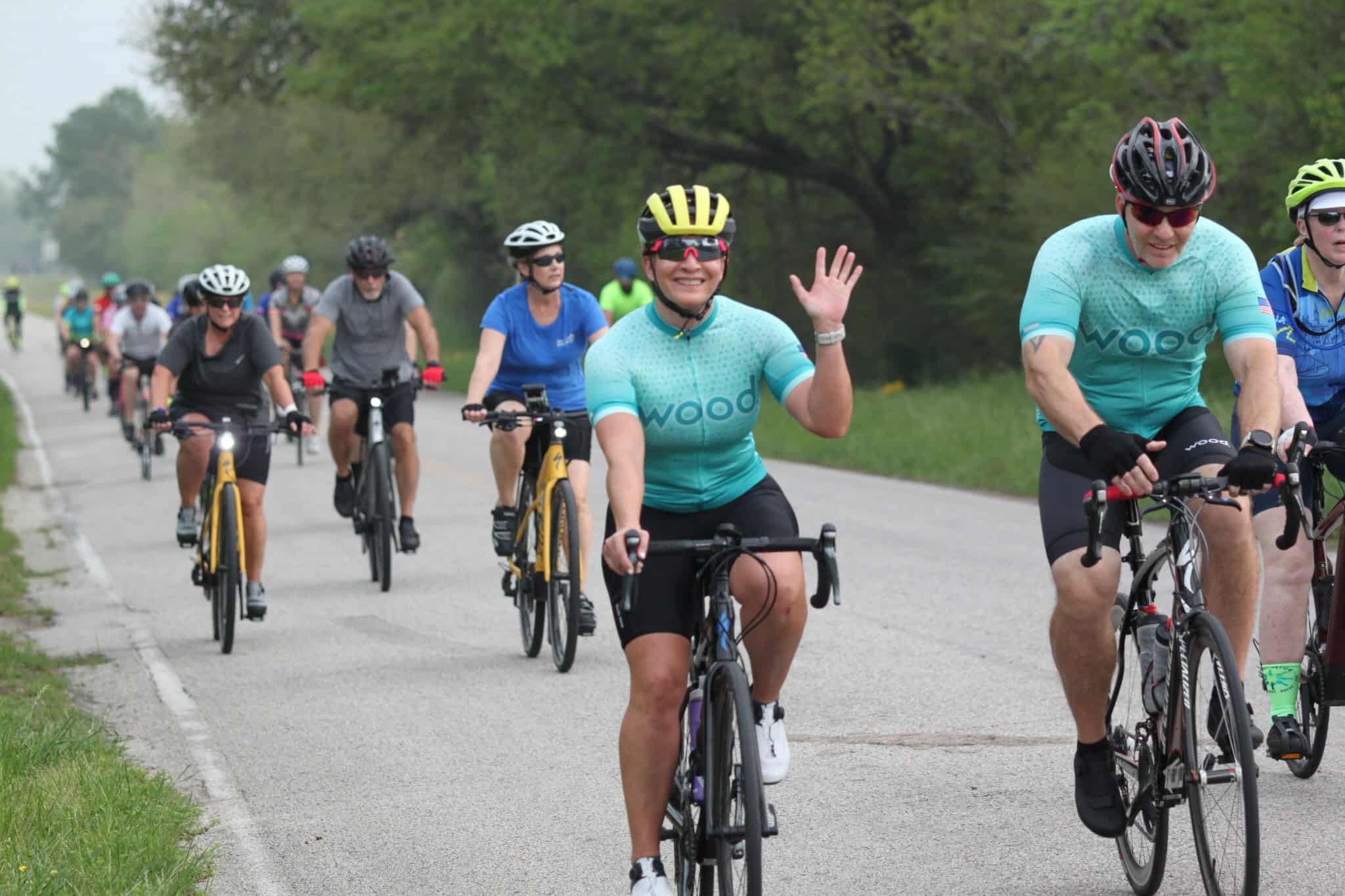 Bright blue cycling jerseys during Bluebonnet Express bike ride event, promoting active lifestyle.