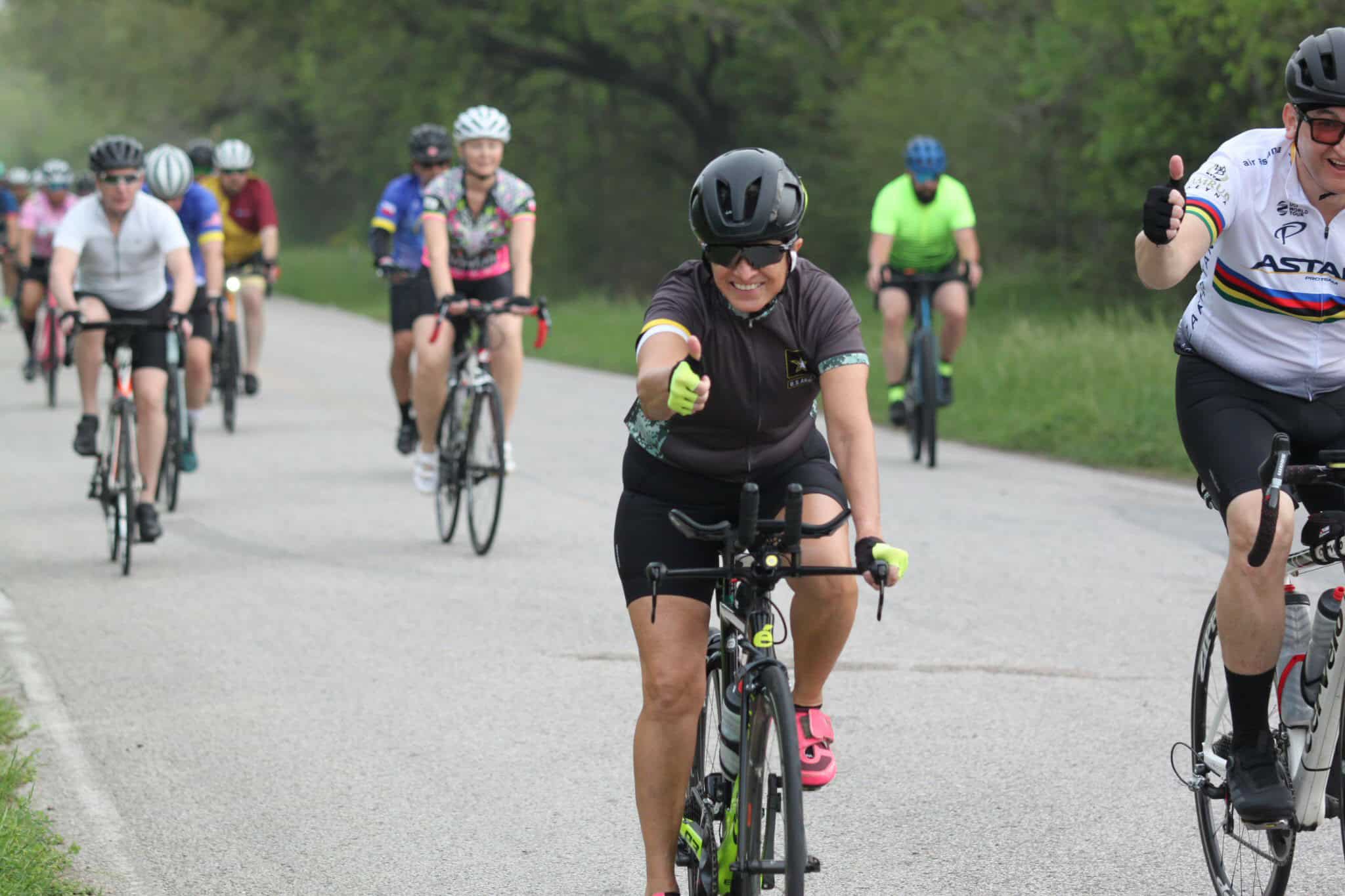 Bright female cyclist smiling during Bluebonnet Express bike ride event, enjoying outdoor cycling.
